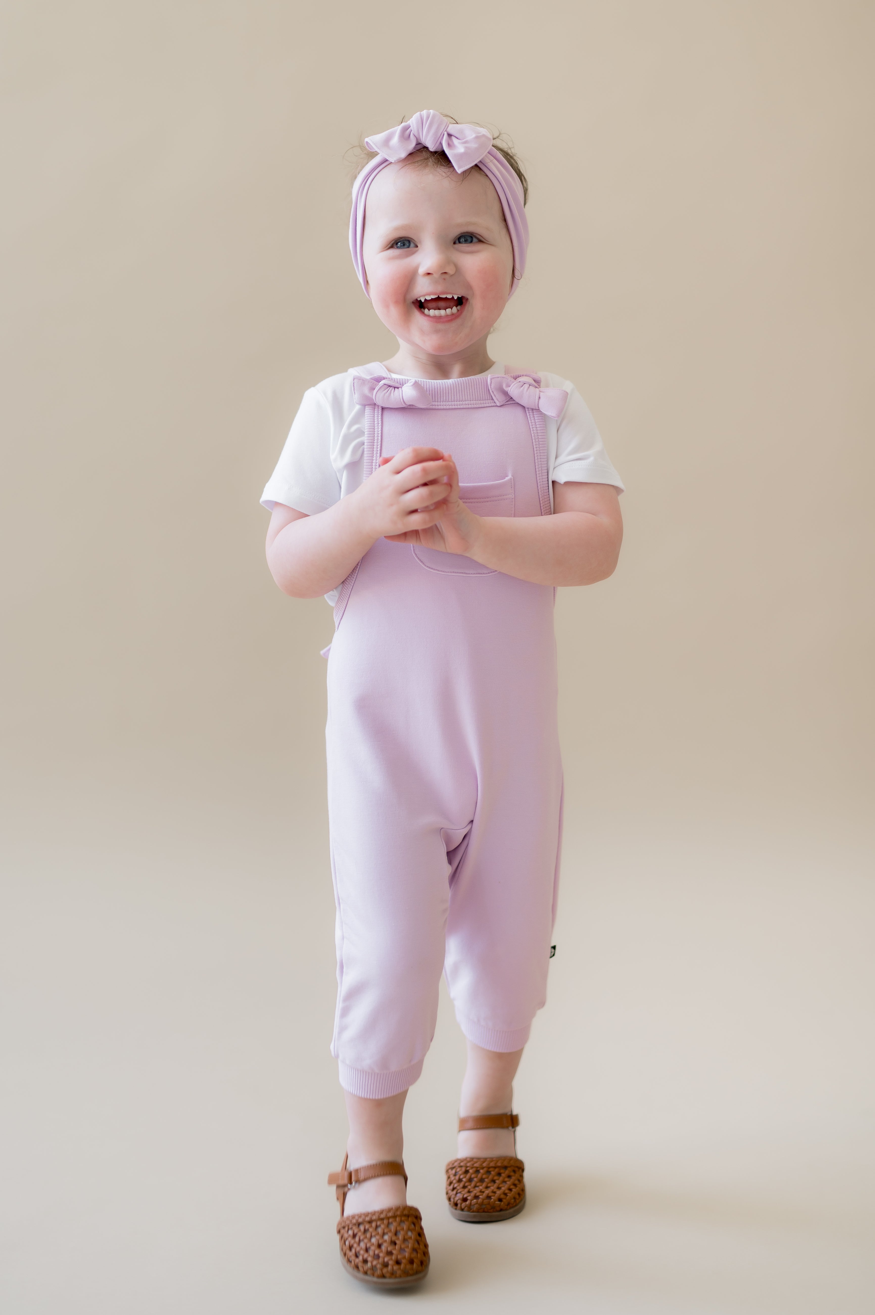 Young girl walking wearing the Overall in Thistle