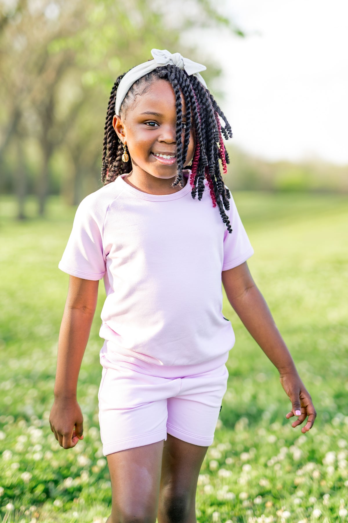Close up of a young girl wearing the Short Sleeve Jogger Set in Thistle