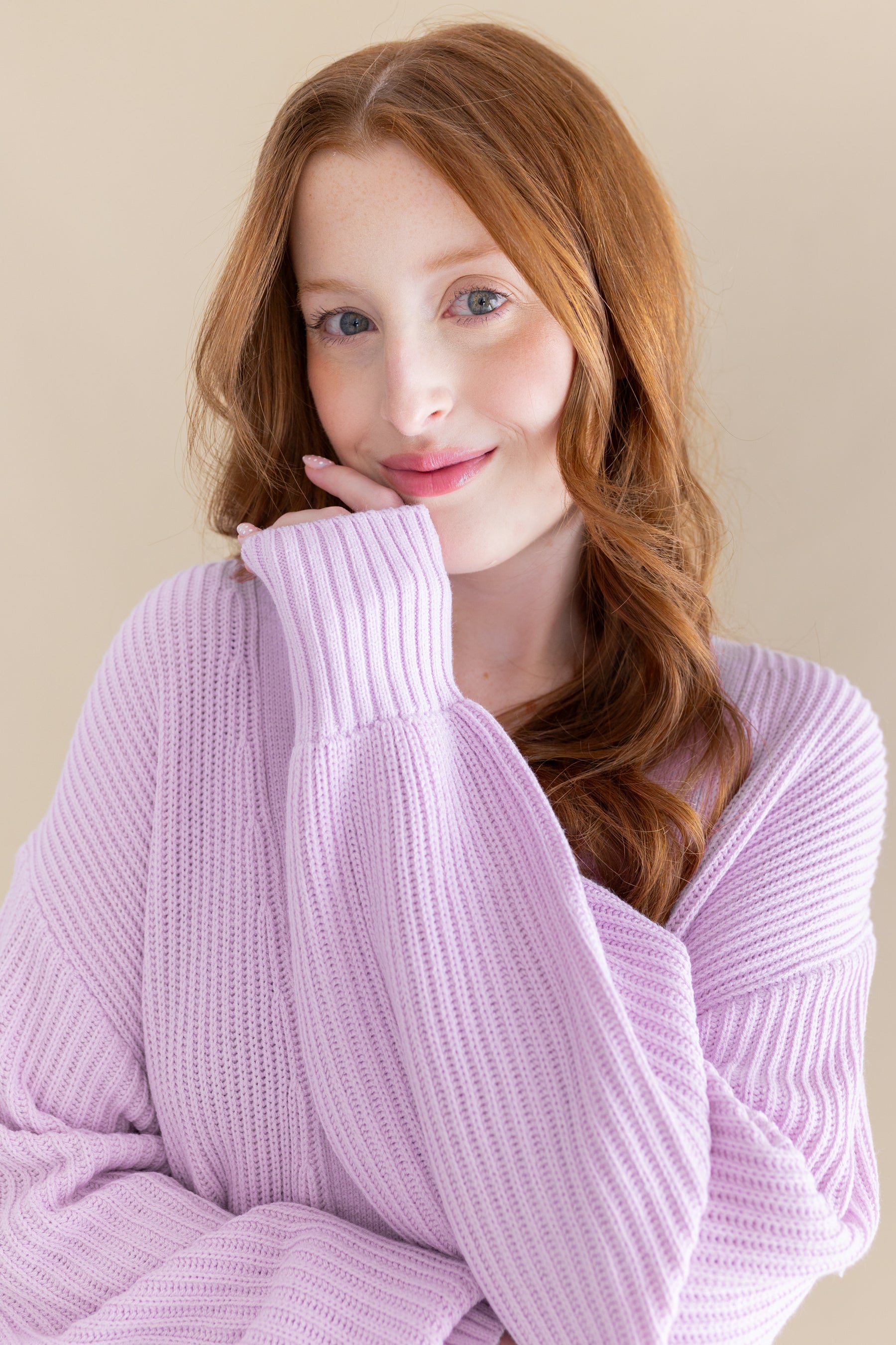 Woman wearing a light purple knit cardigan