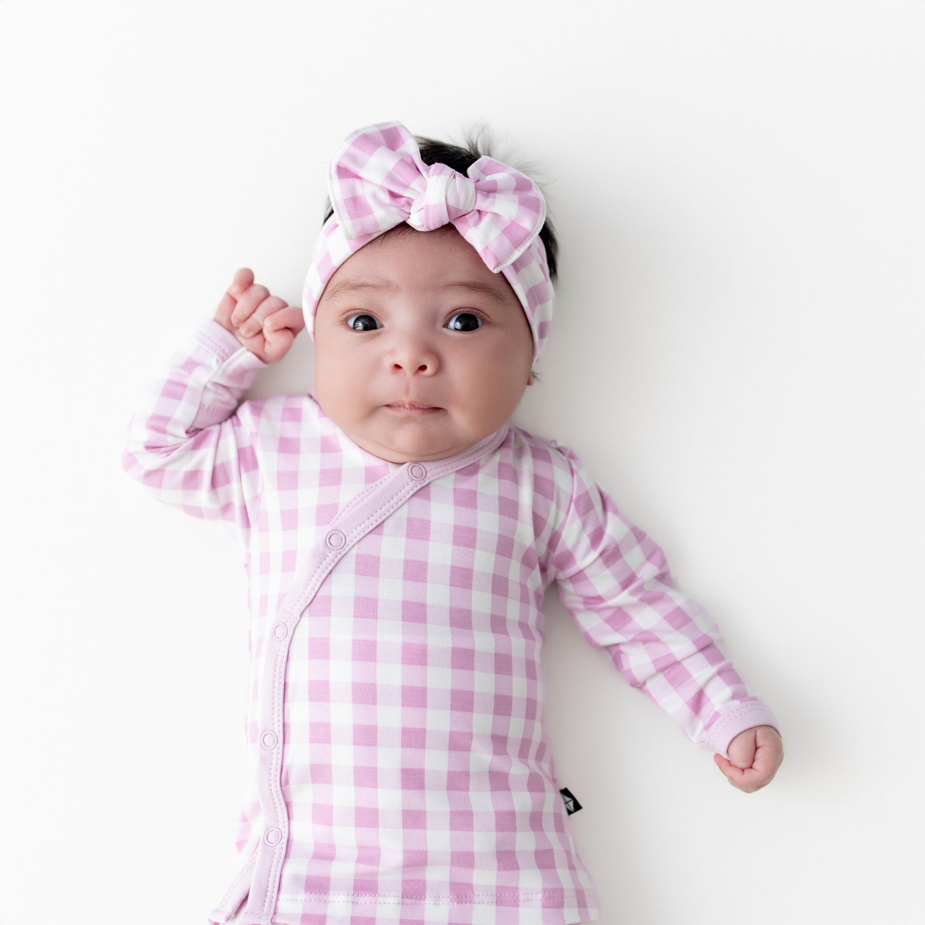Close up of newborn wearing the Take Me Home Set with Bow in Gingham Thistle