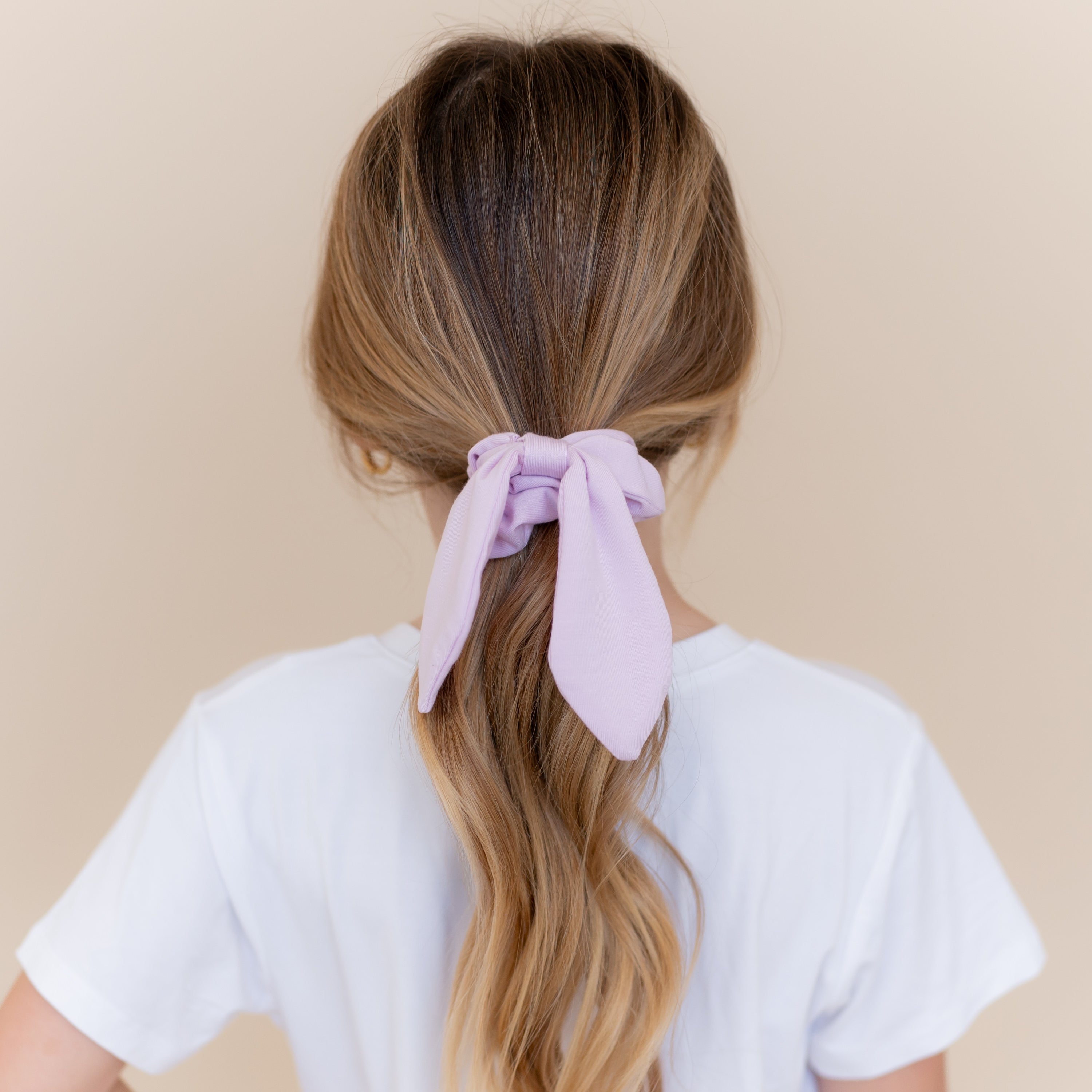 Scrunchie in Thistle shown in a girls ponytail