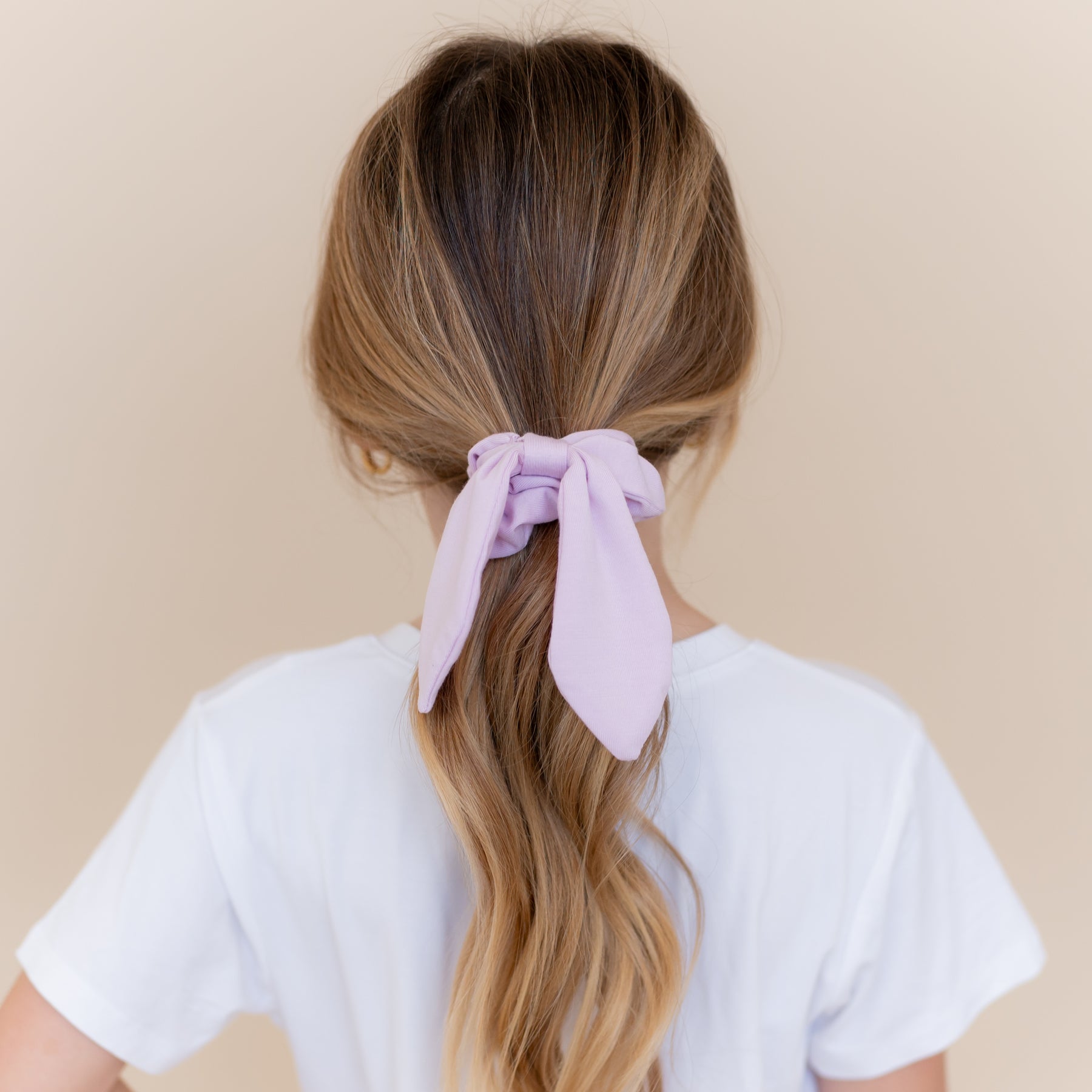 Scrunchie in Thistle shown in a girls ponytail