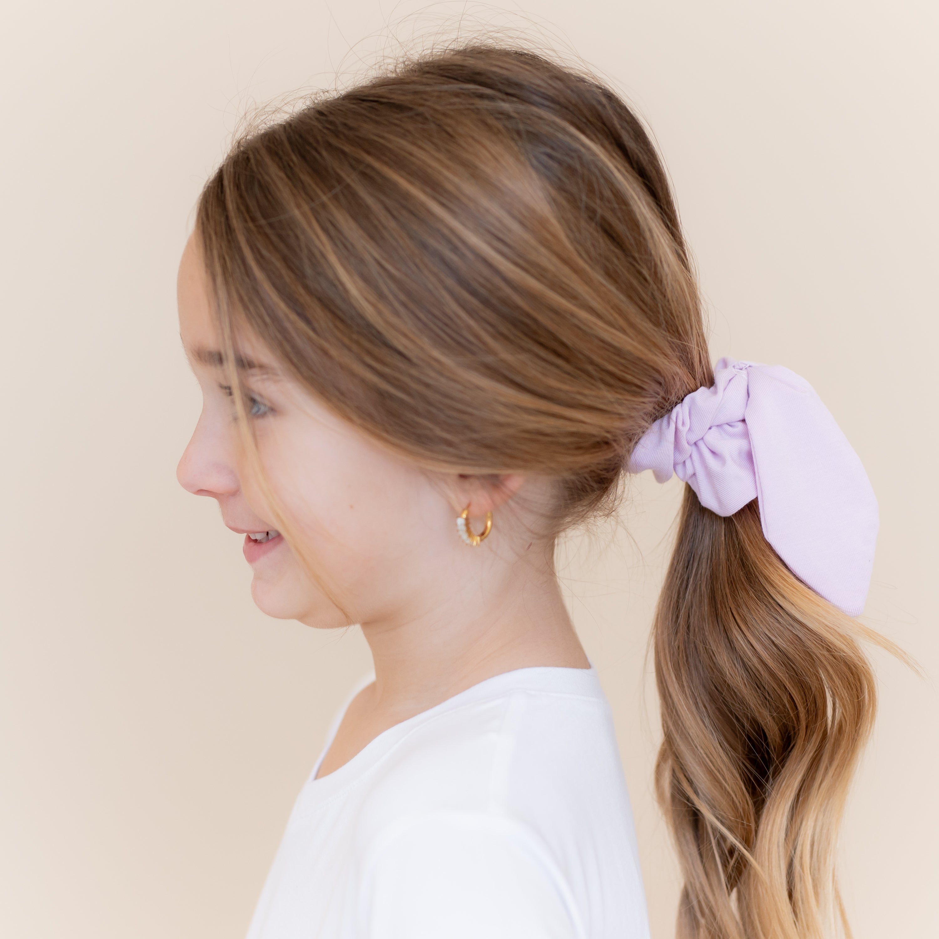 Scrunchie in Thistle shown in a young girls hair