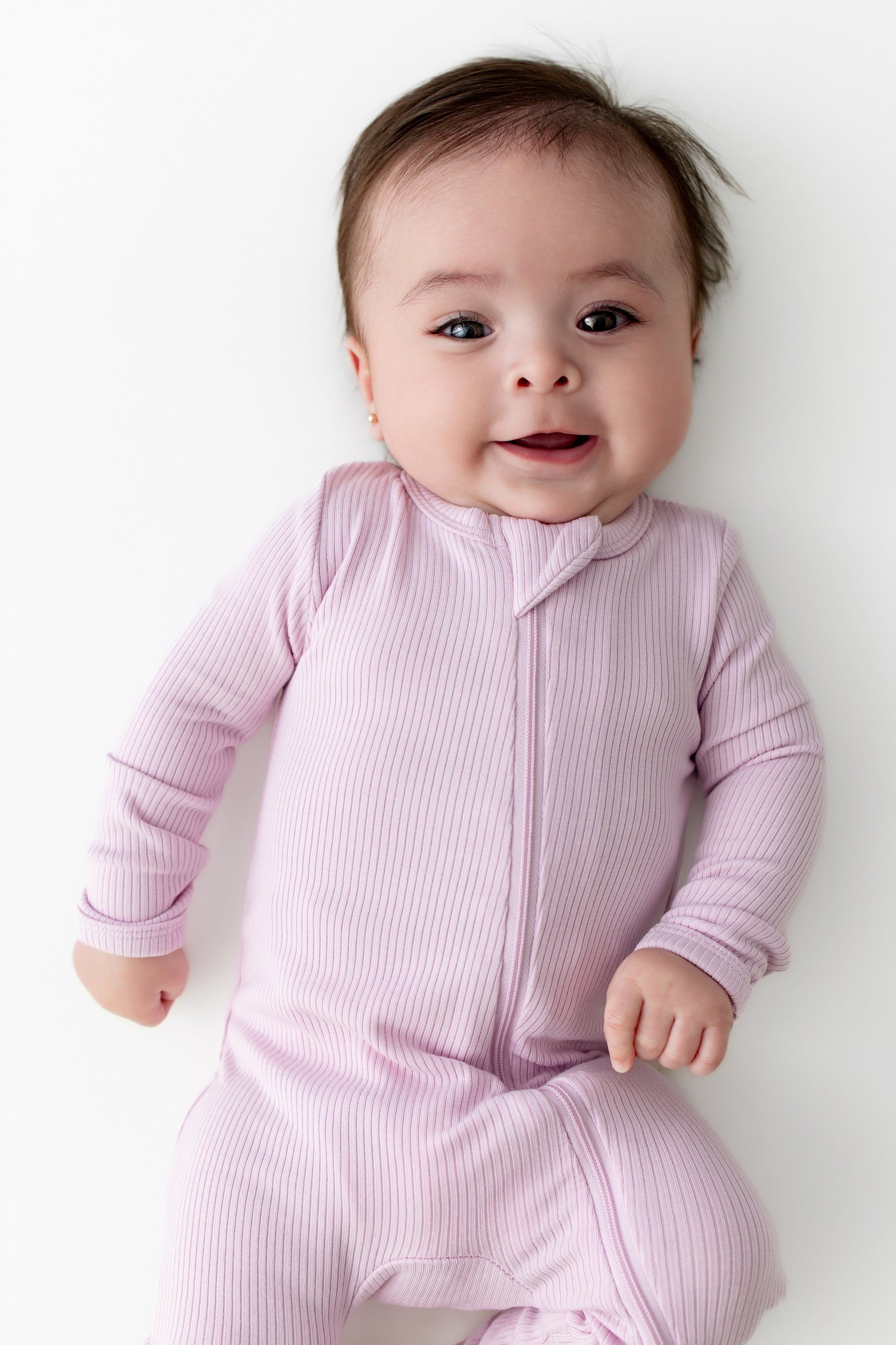 Close up of infant wearing the Ribbed Zipper Romper in Thistle