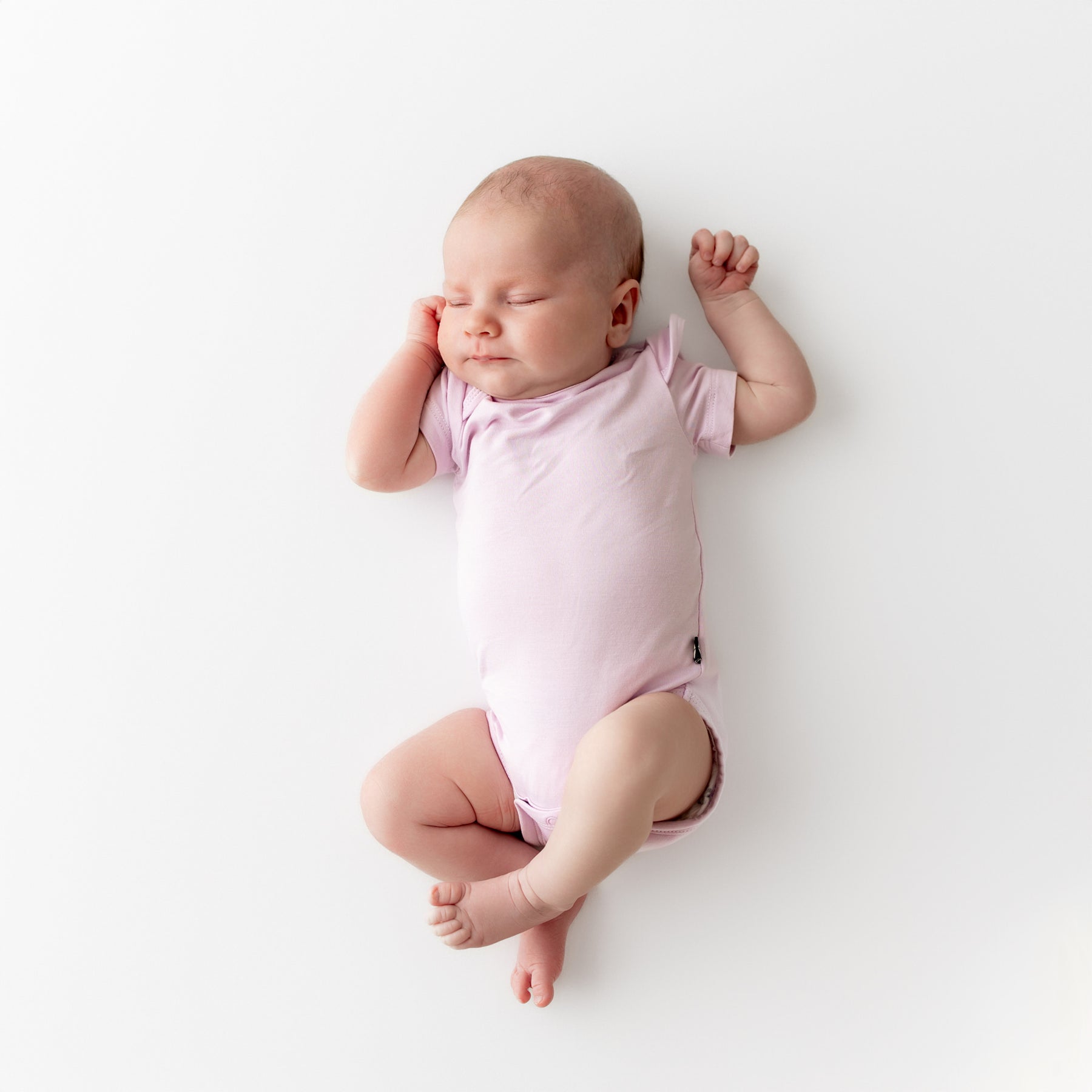 Baby wearing light purple bodysuit