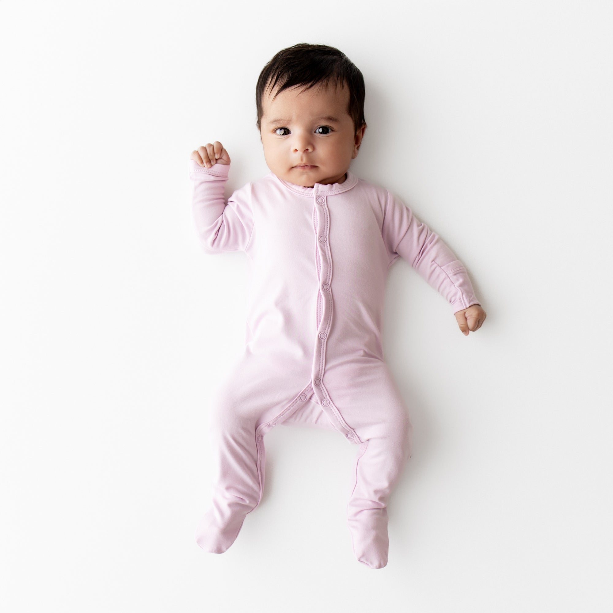 Baby wearing a snap footie in a light purple color