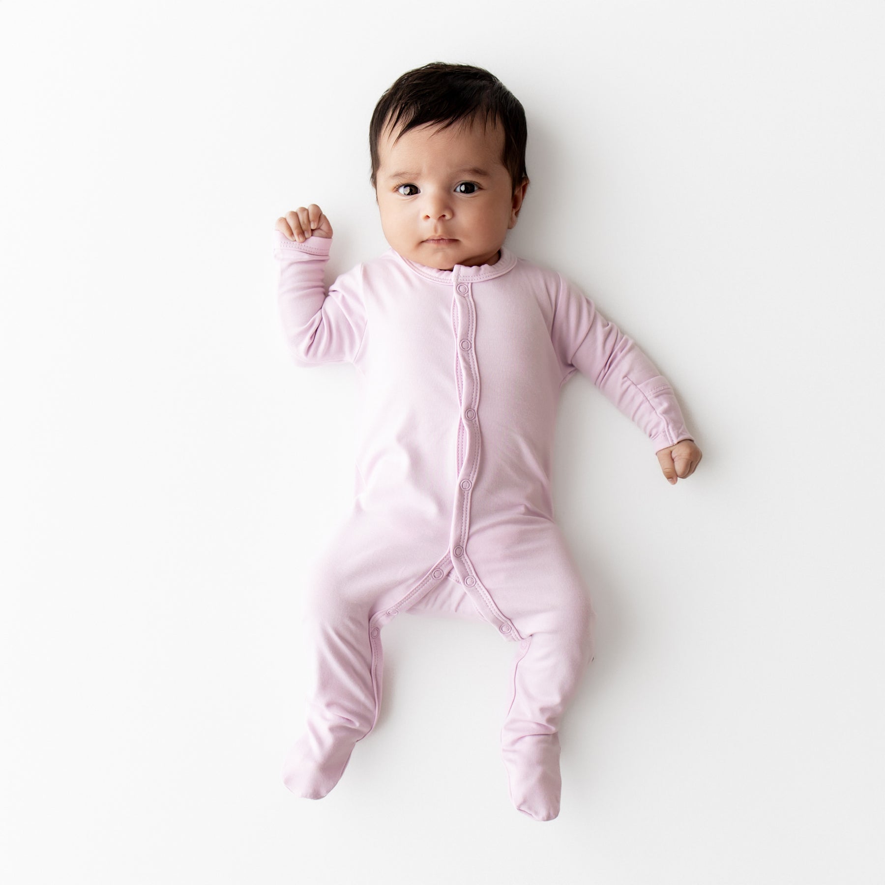 Baby wearing a snap footie in a light purple color