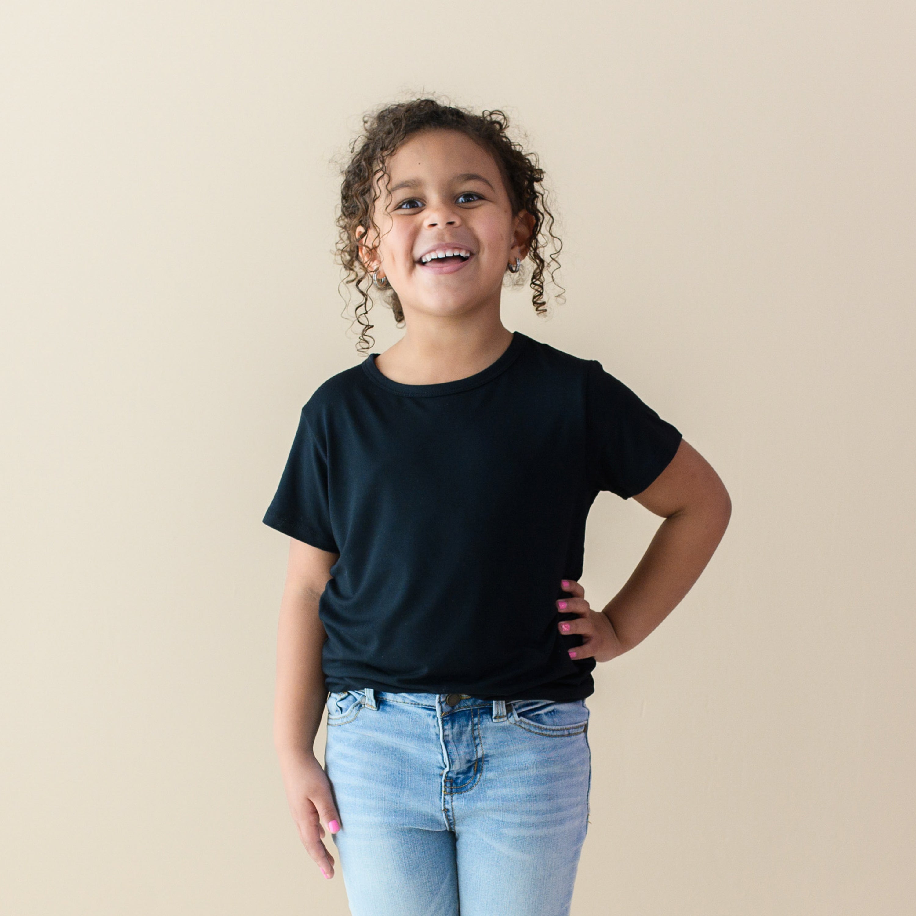 Smiling toddler with hand on hip and wearing Toddler Basic Tee in Midnight