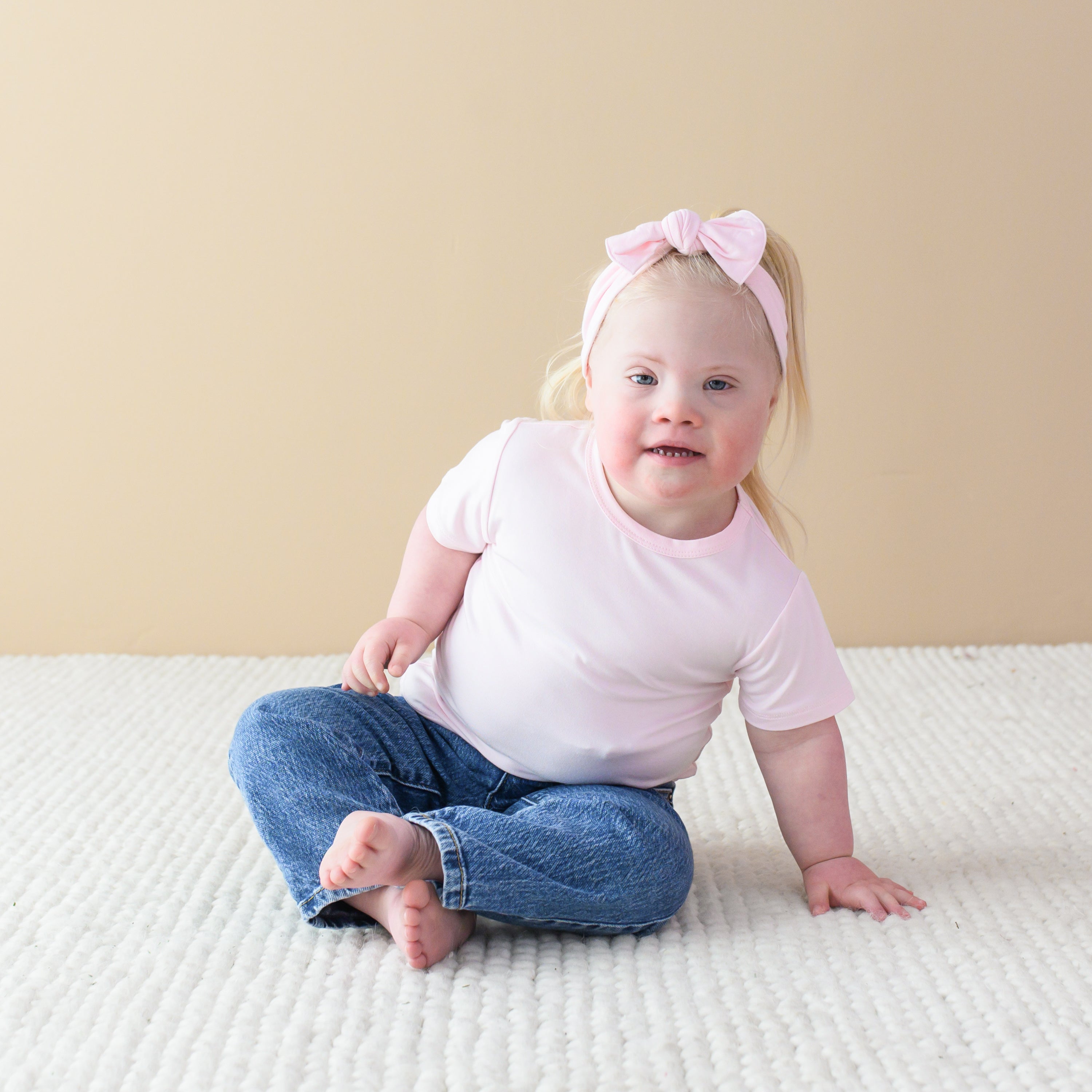 Toddler wearing Short Sleeve Basic Tee in Sakura Pink and Matching Knotted Bow