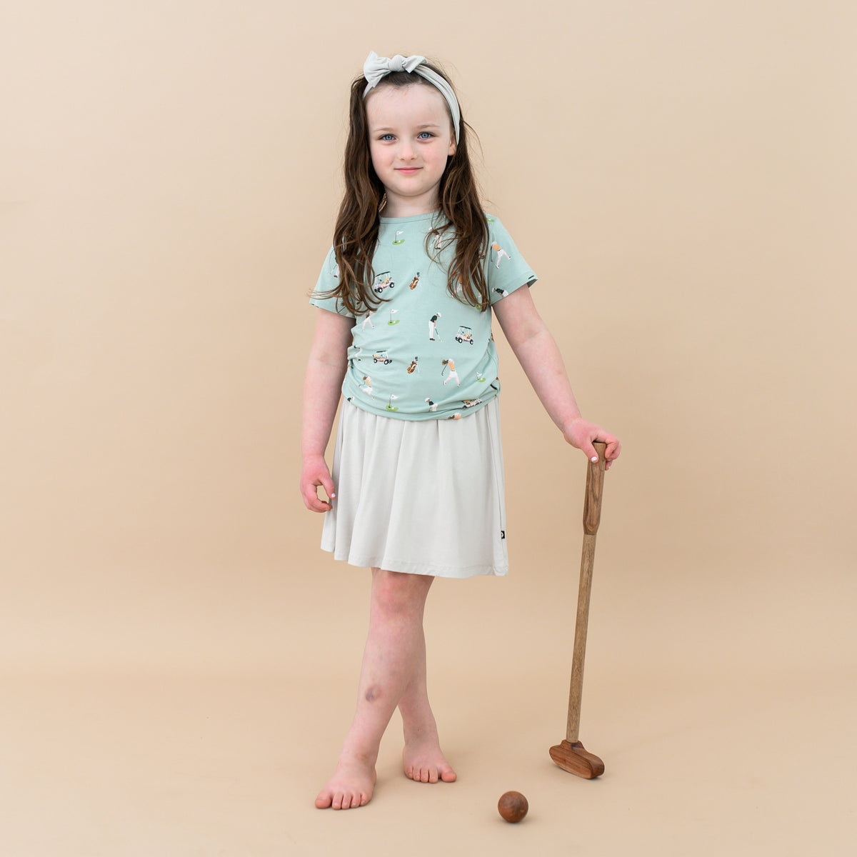 Toddler modeling Toddler Basic Tee in Golf and oat Skort with toy golf club