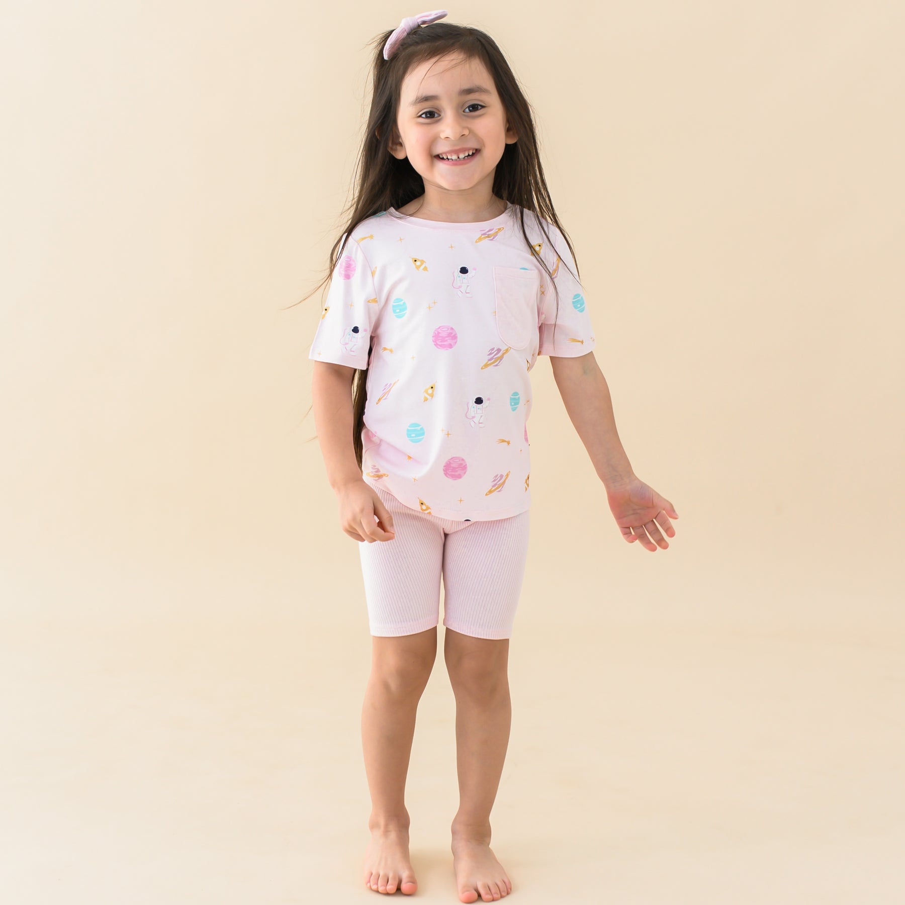 toddler in sakura space crew neck tee and sakura ribbed biker shorts