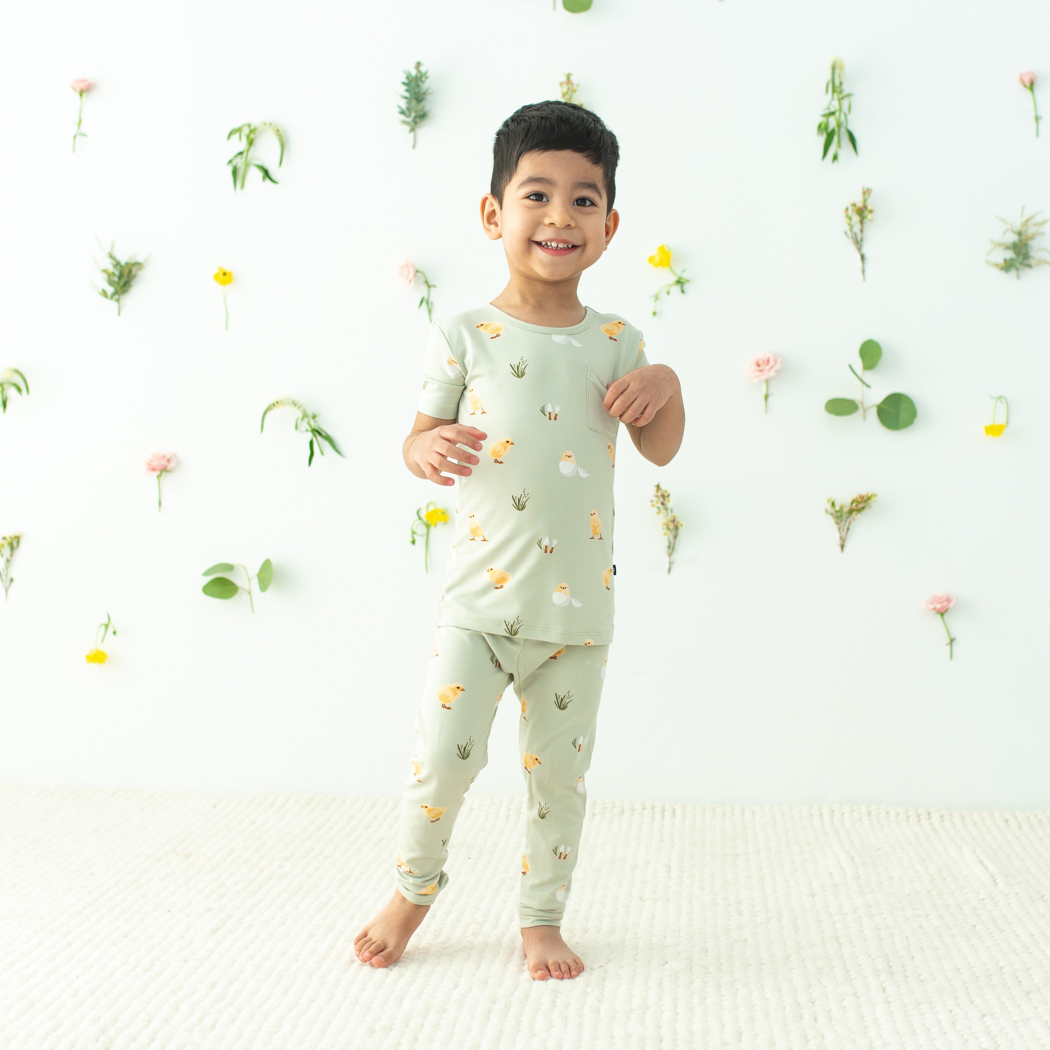 Toddler modeling Short Sleeve with Pants Pajamas in Aloe Chick