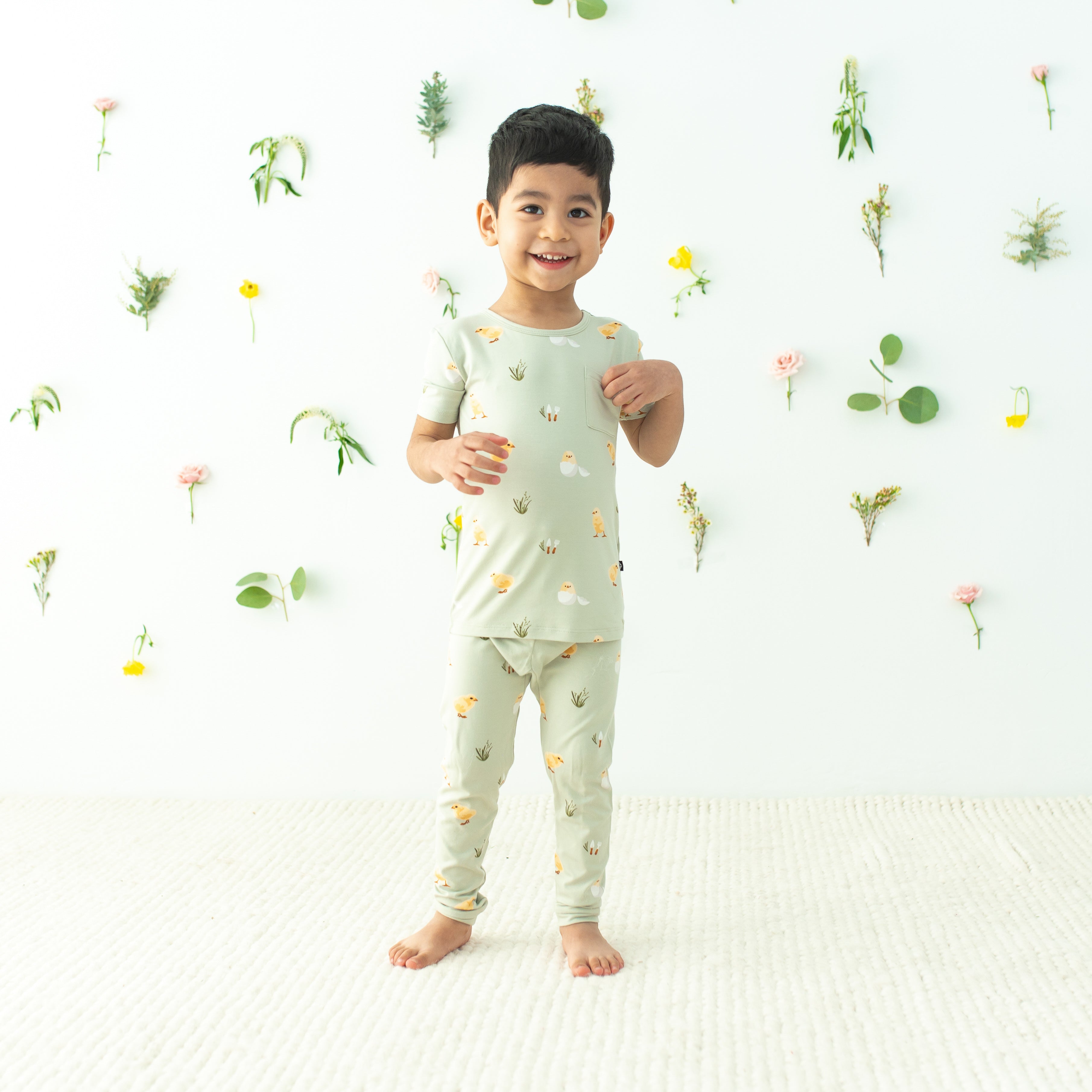 Toddler modeling Short Sleeve with Pants Pajamas in Aloe Chick