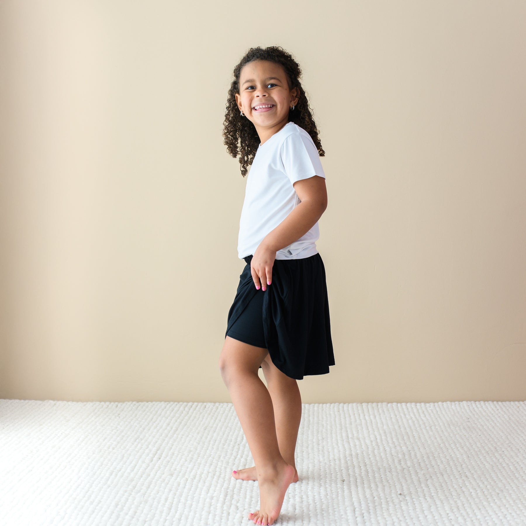 Toddler modeling Toddler Skort in Midnight showing there are built in shorts