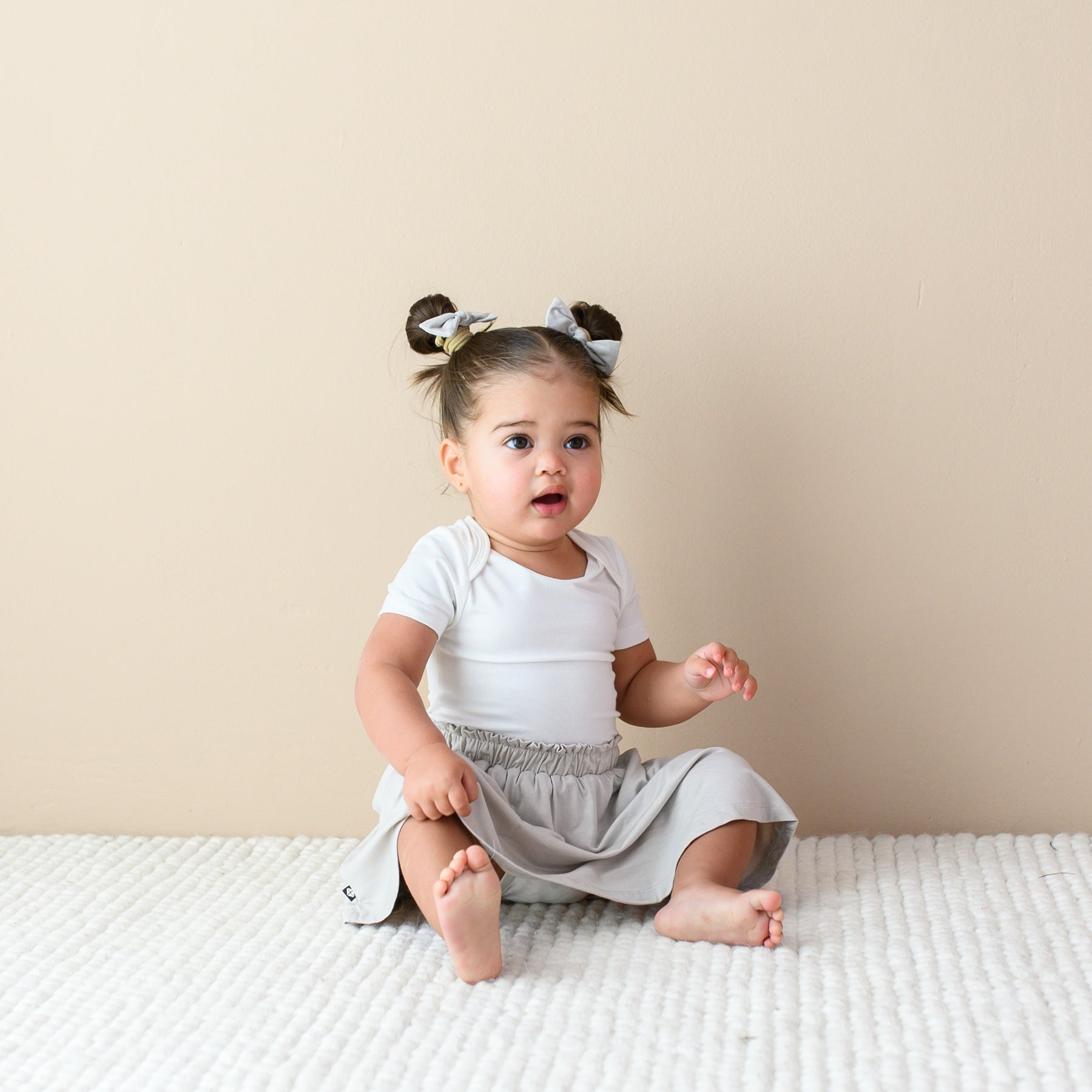 toddler modeling Toddler Skort in Oat and bodysuit in cloud