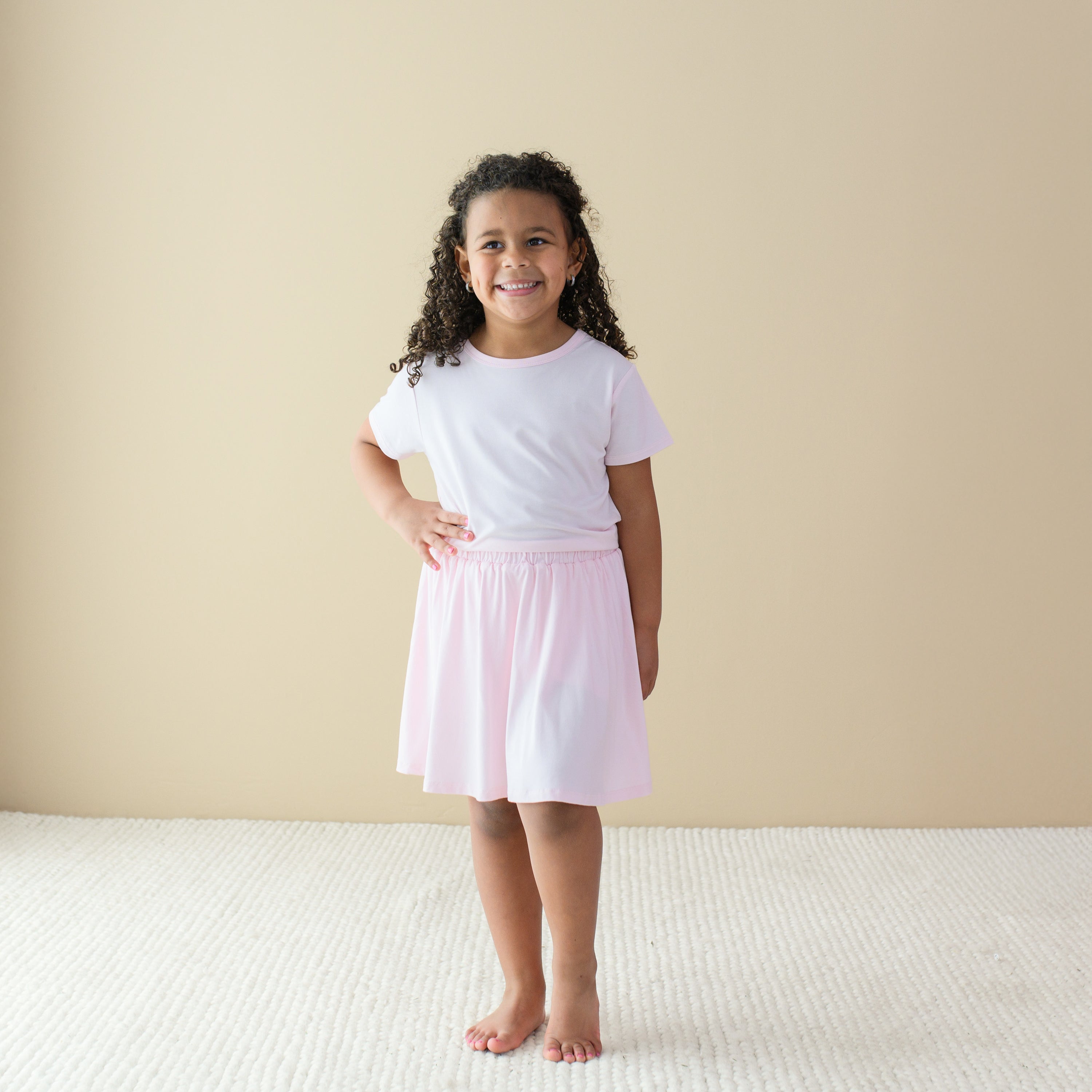 Toddler modeling Toddler Skort in Sakura and basic tee