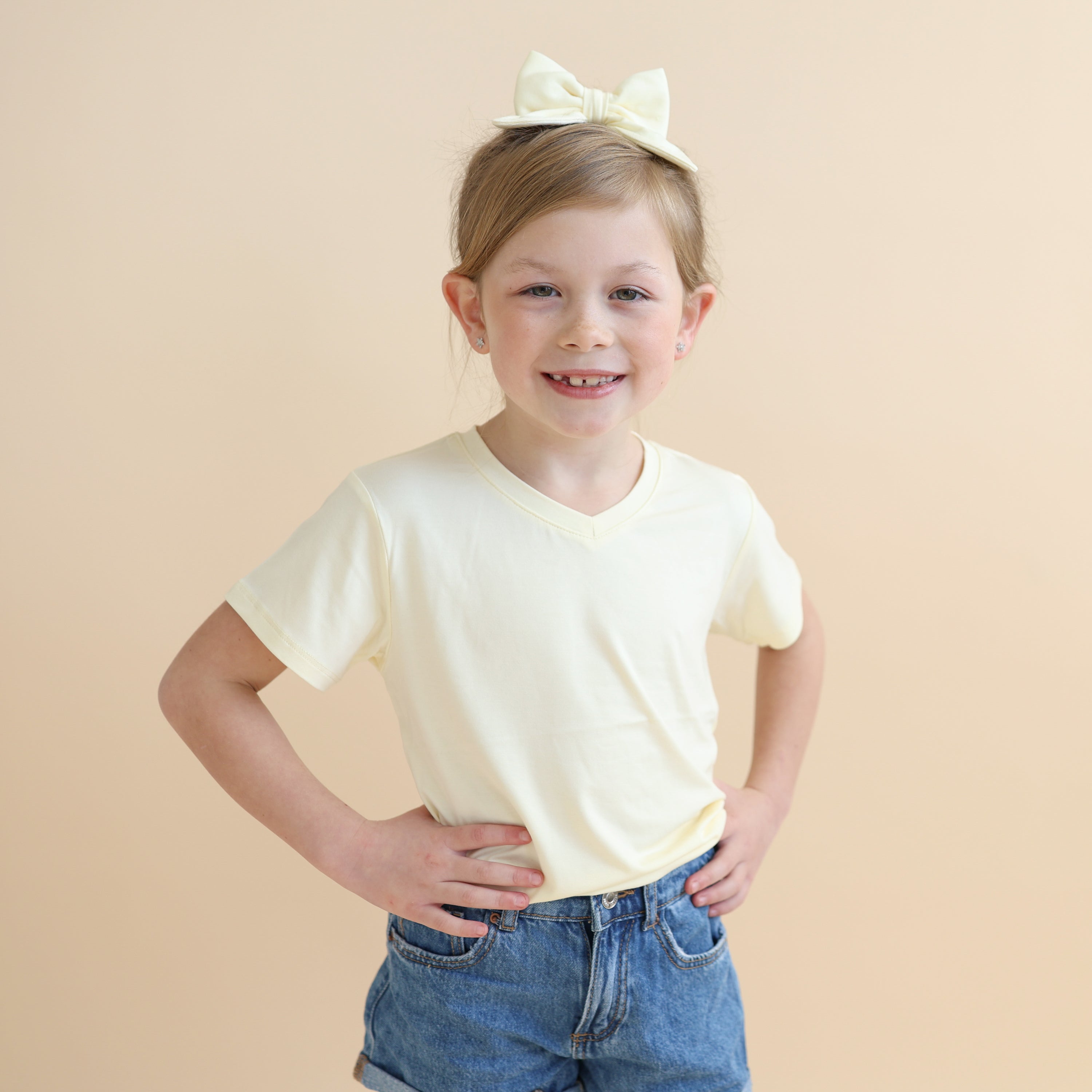 Close up of young girl wearing the Toddler V-Neck Tee in Chamomile 