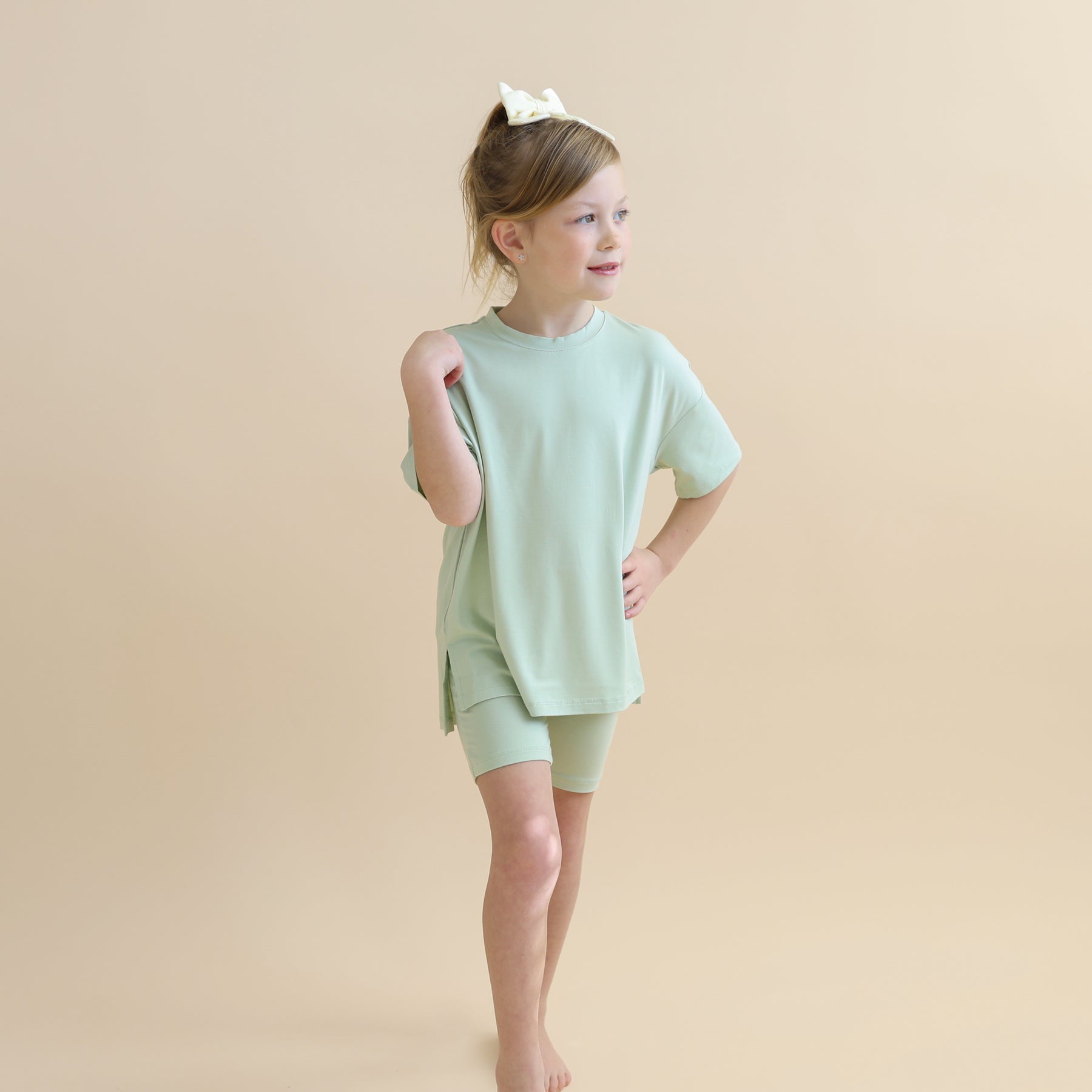 Young girl posing wearing the Toddler Biker Short Set in Basil