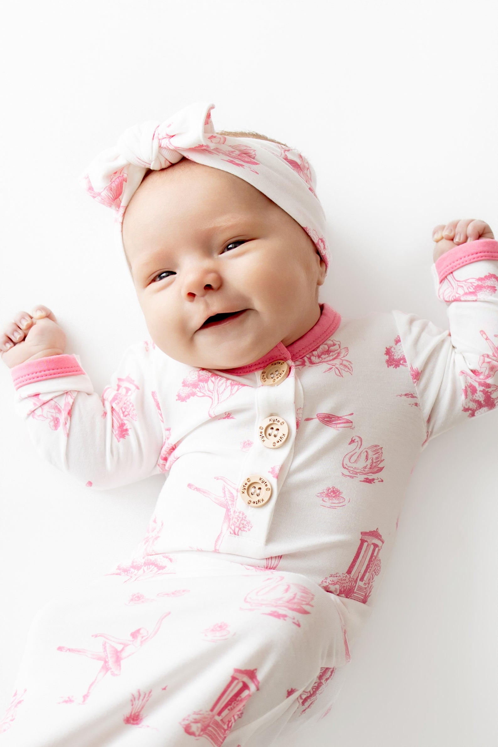 Close up of infant wearing the Knotted Gown with Bow Set in Toile Ballet