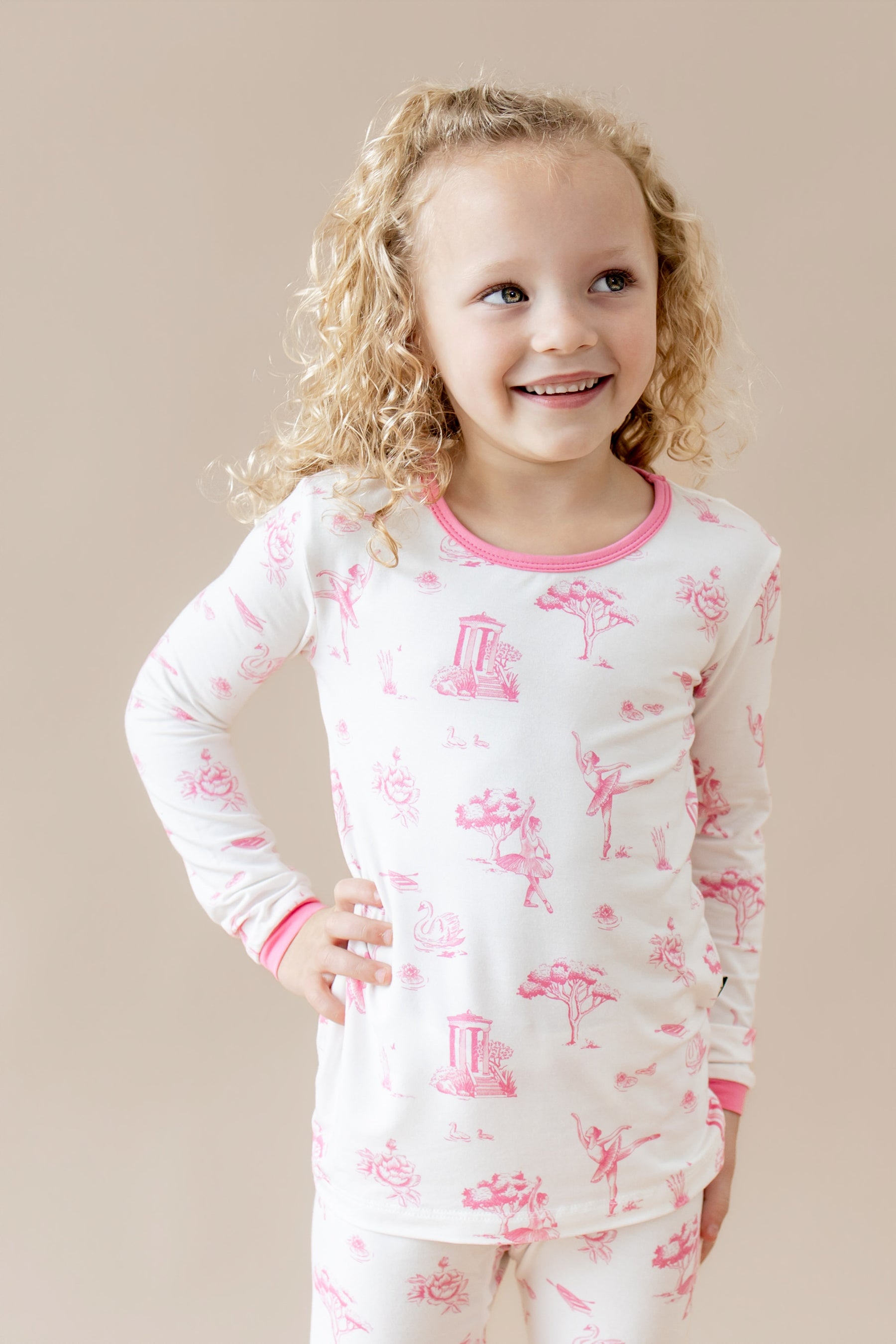 Close up of young girl posing wearing the Long Sleeve Pajamas in Toile Ballet