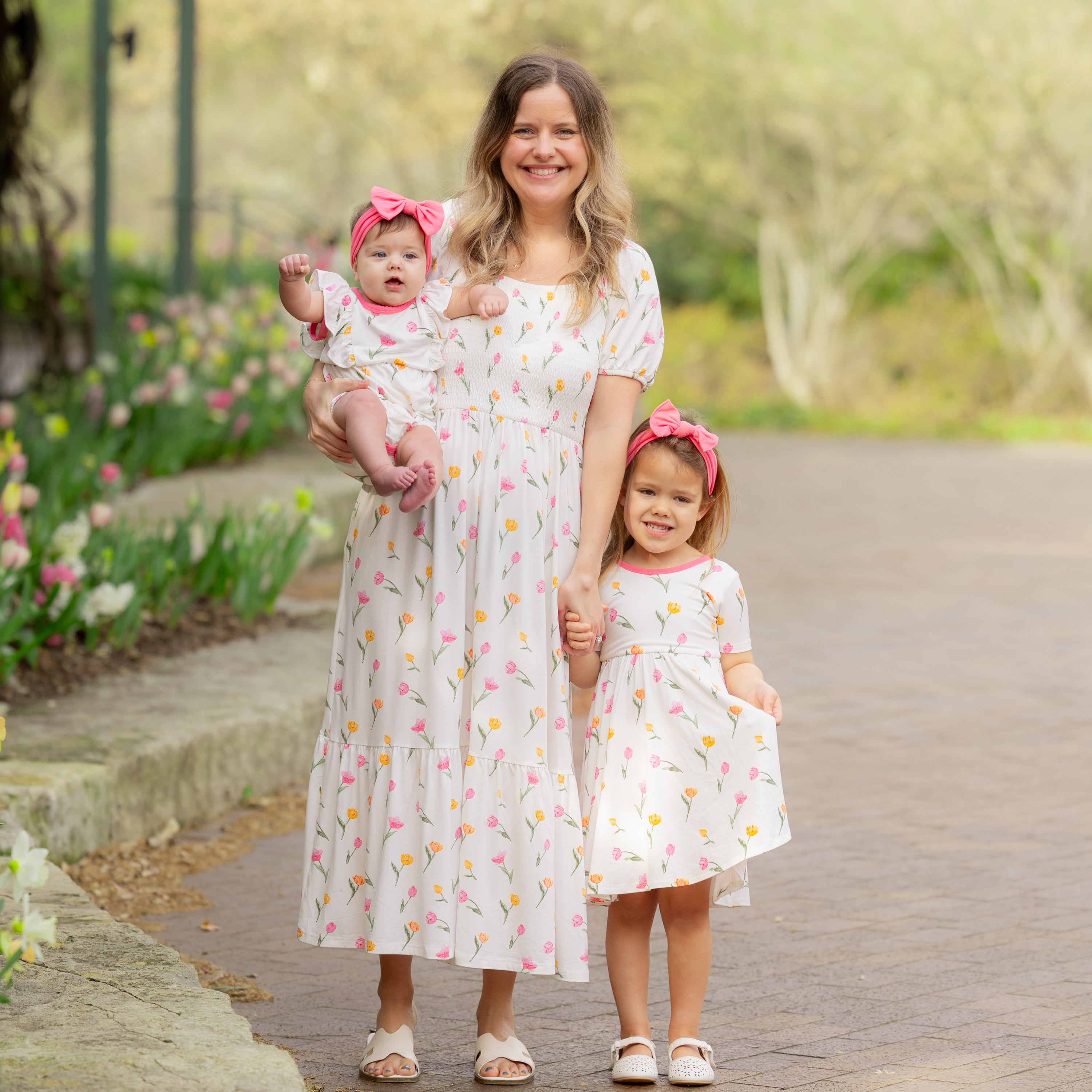 Mother with her two daughters wearing dresses from the Tulip collection