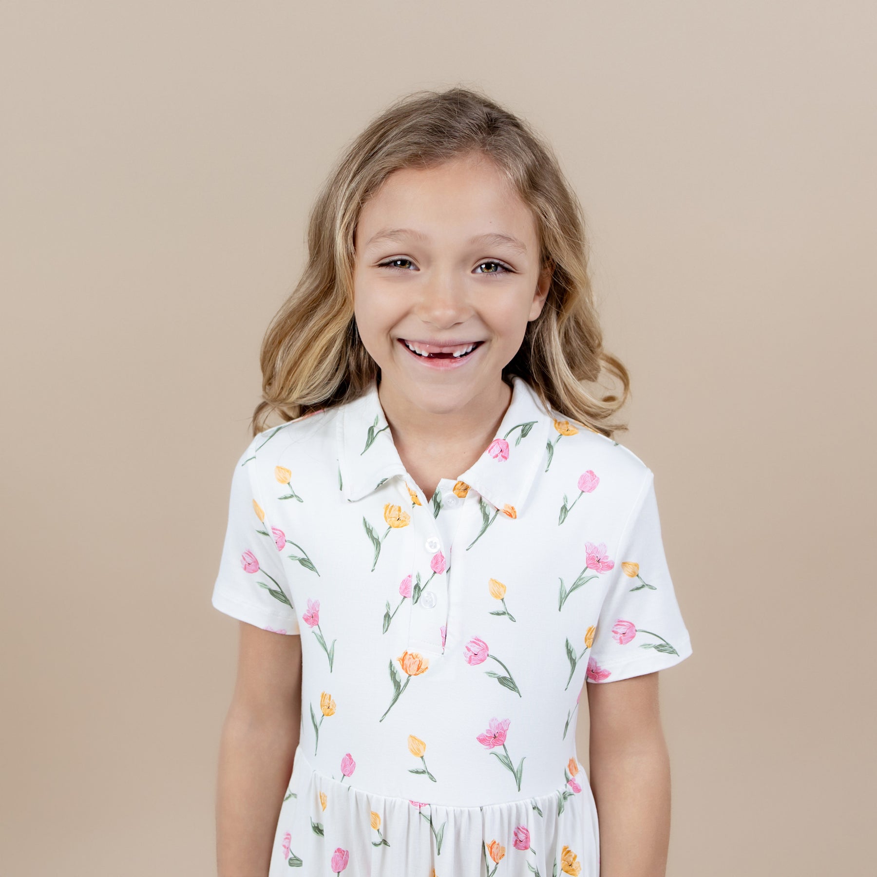 Close up a young girl wearing the Polo Dress in Tulip