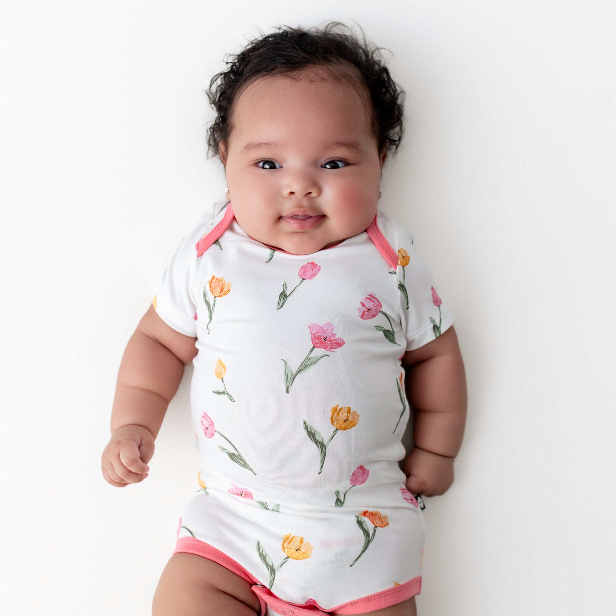 Close up of newborn wearing the Bodysuit in Tulip