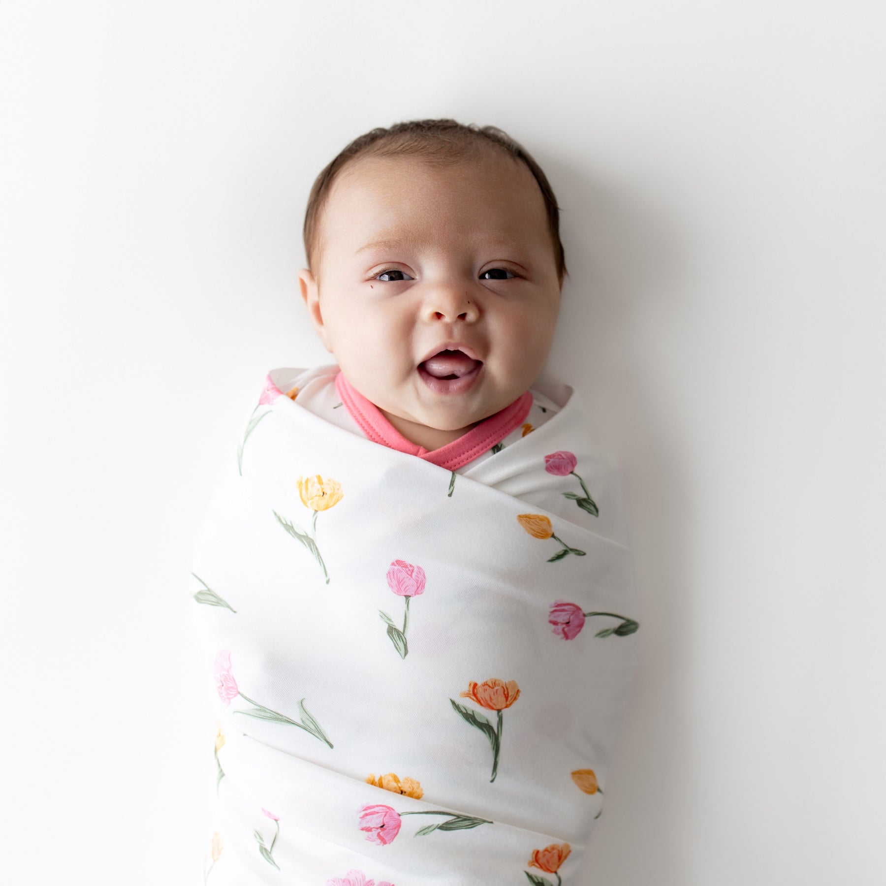 Close up of a newborn swaddled in the Swaddle Blanket in Tulip