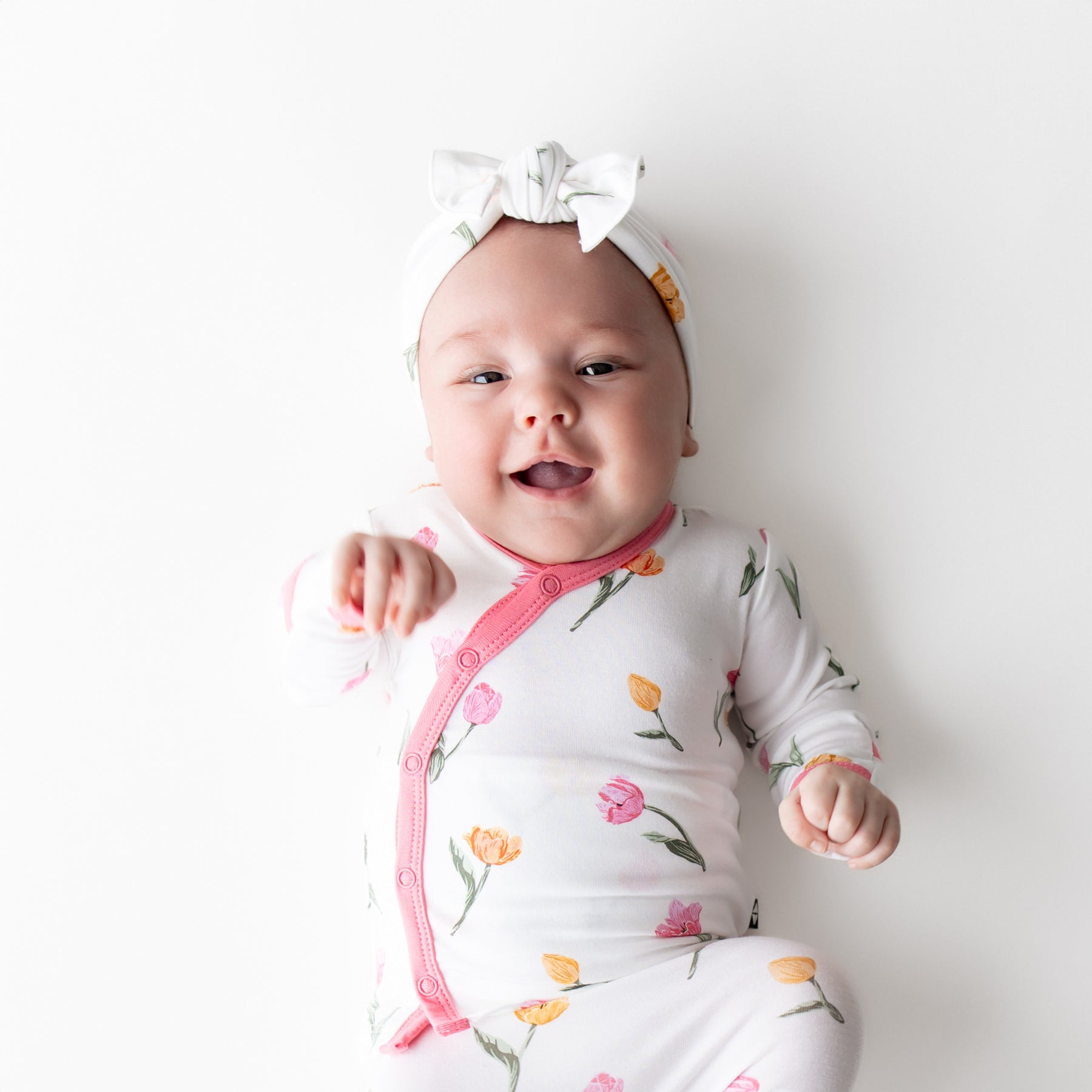 Close up of newborn wearing the Take Me Home Set with Bow in Tulip