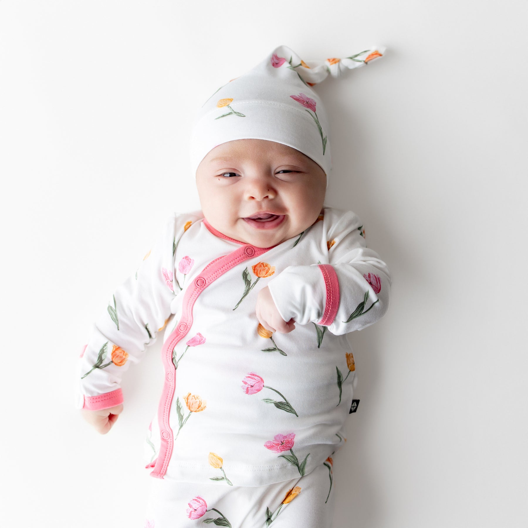 Close up of newborn wearing the Take Me Home Set with Cap in Tulip