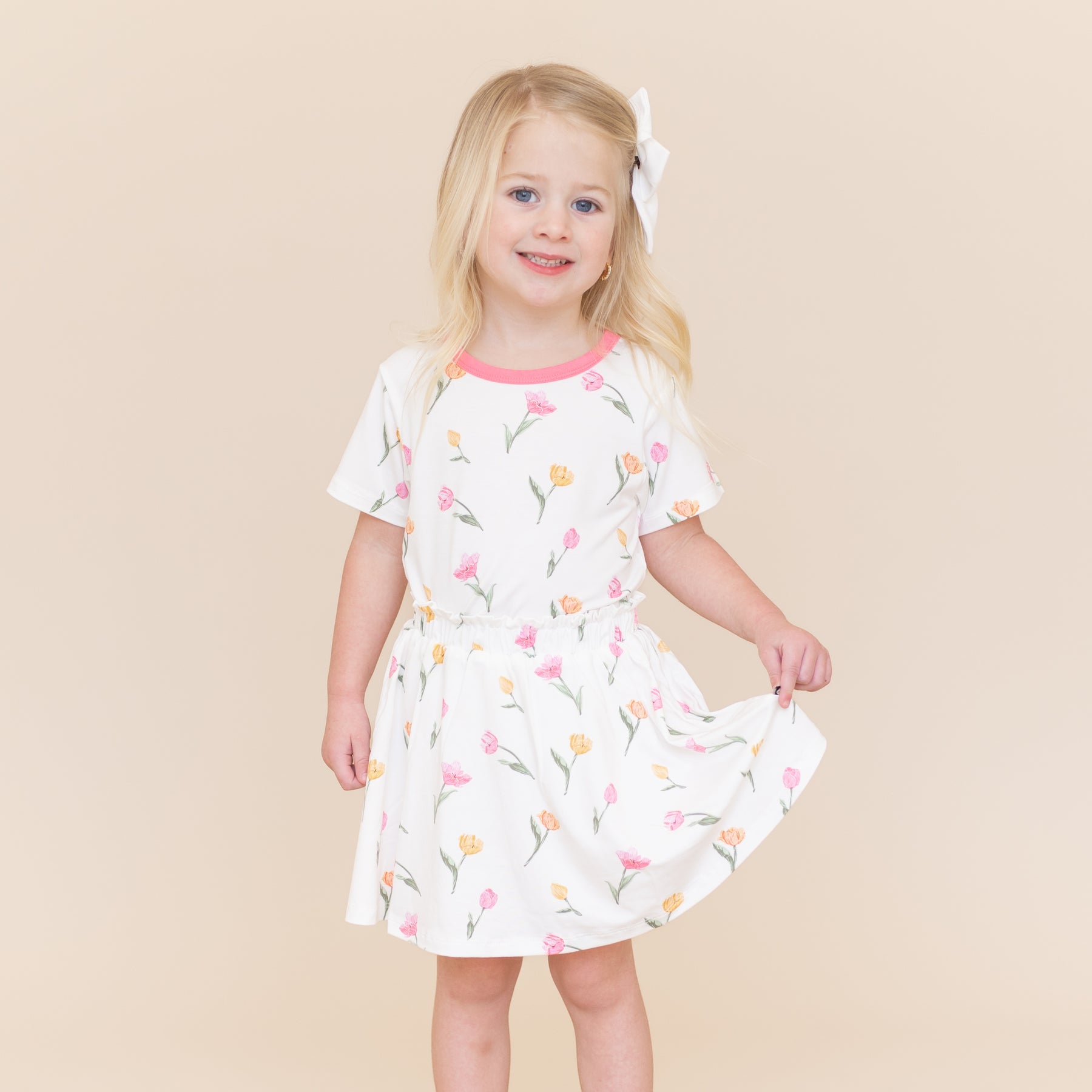 Young girl modeling the Toddler Basic Tee in Tulip paired with a matching basic tee