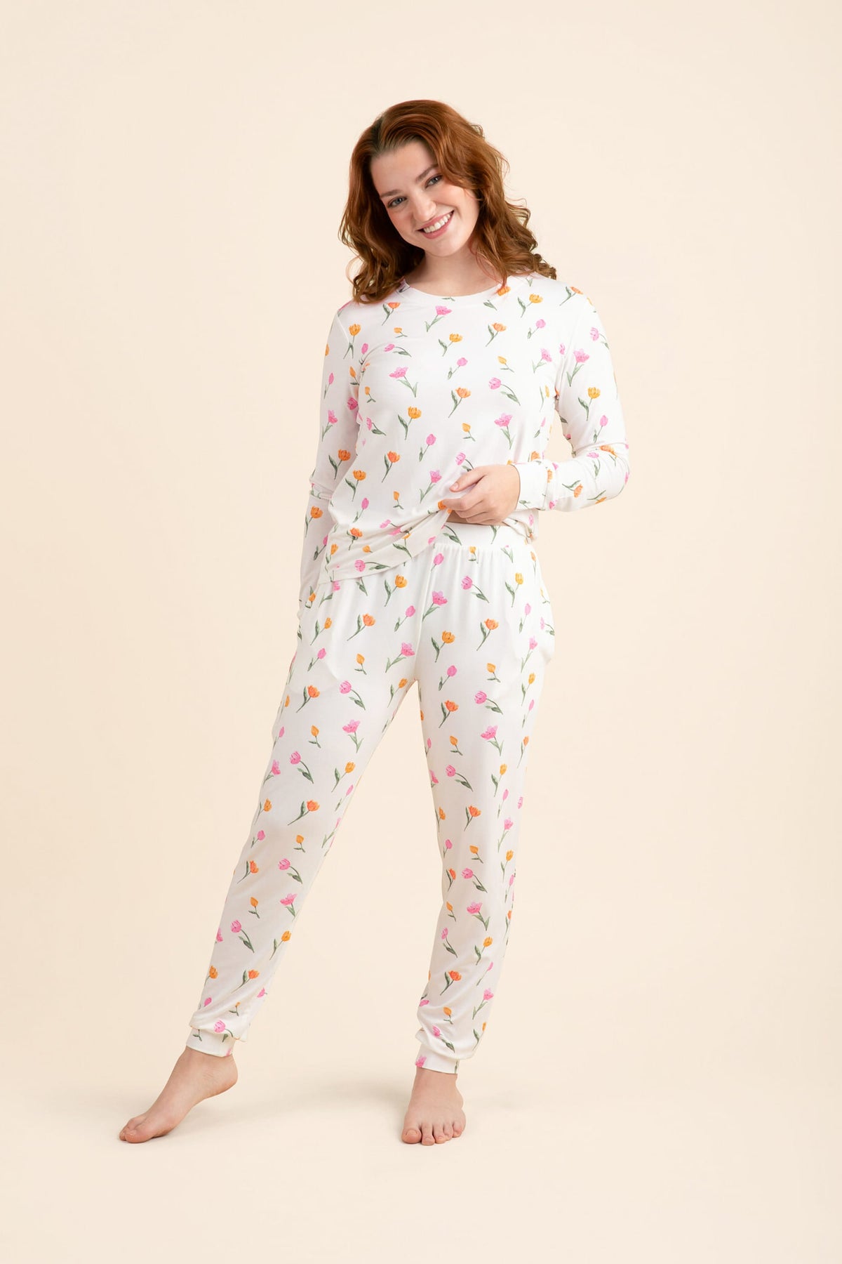 Female modeling the Women's Jogger Pajama Set in Tulip posing in front of a light neutral background
