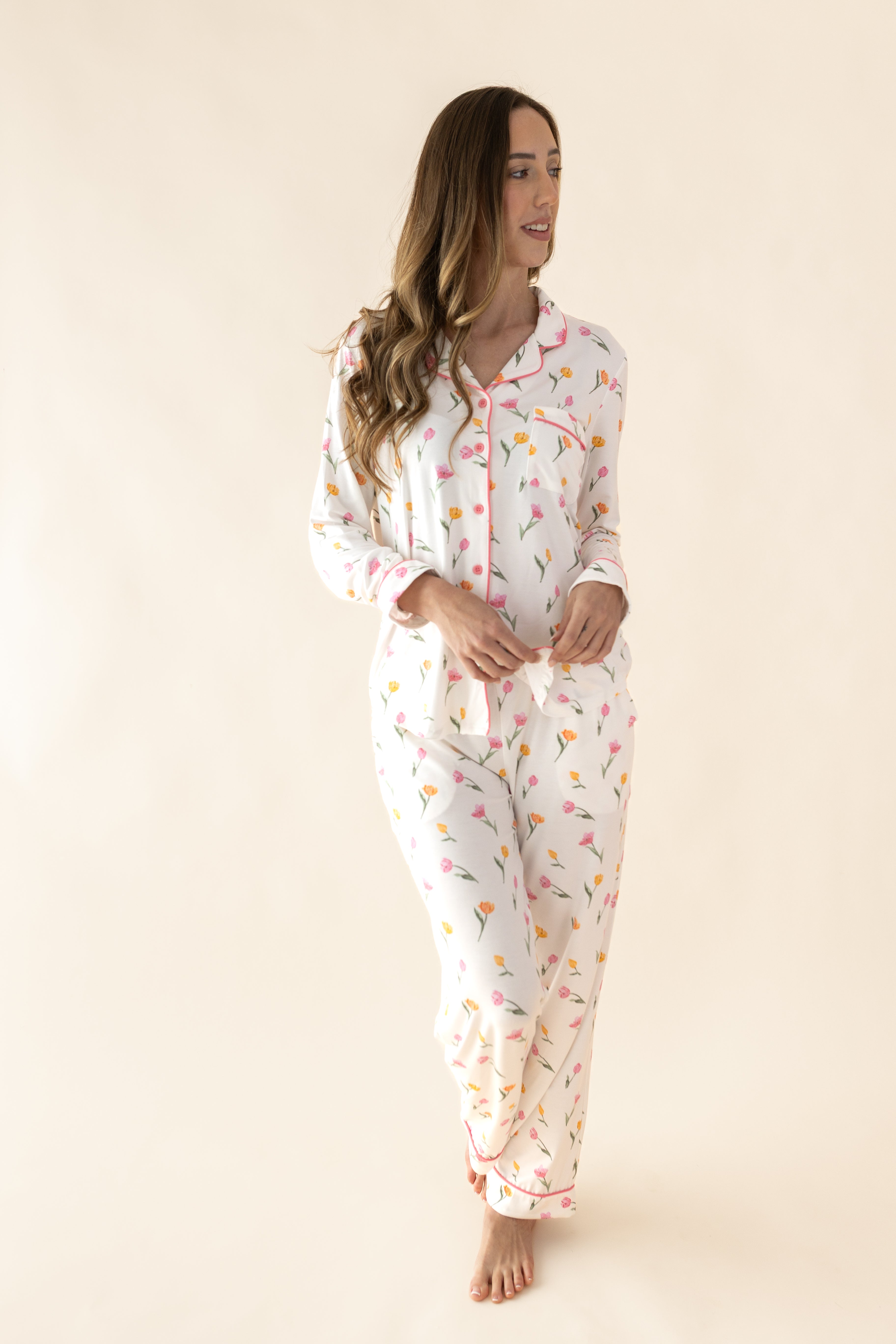 Female standing in front of a light taupe background wearing the Long Sleeve Women’s Nightshirt in Tulip