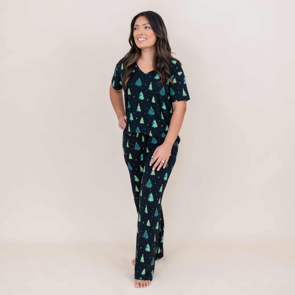 Smiling female model wearing the Women's Relaxed Fit V-Neck in Twinkle Tree and matching lounge pants