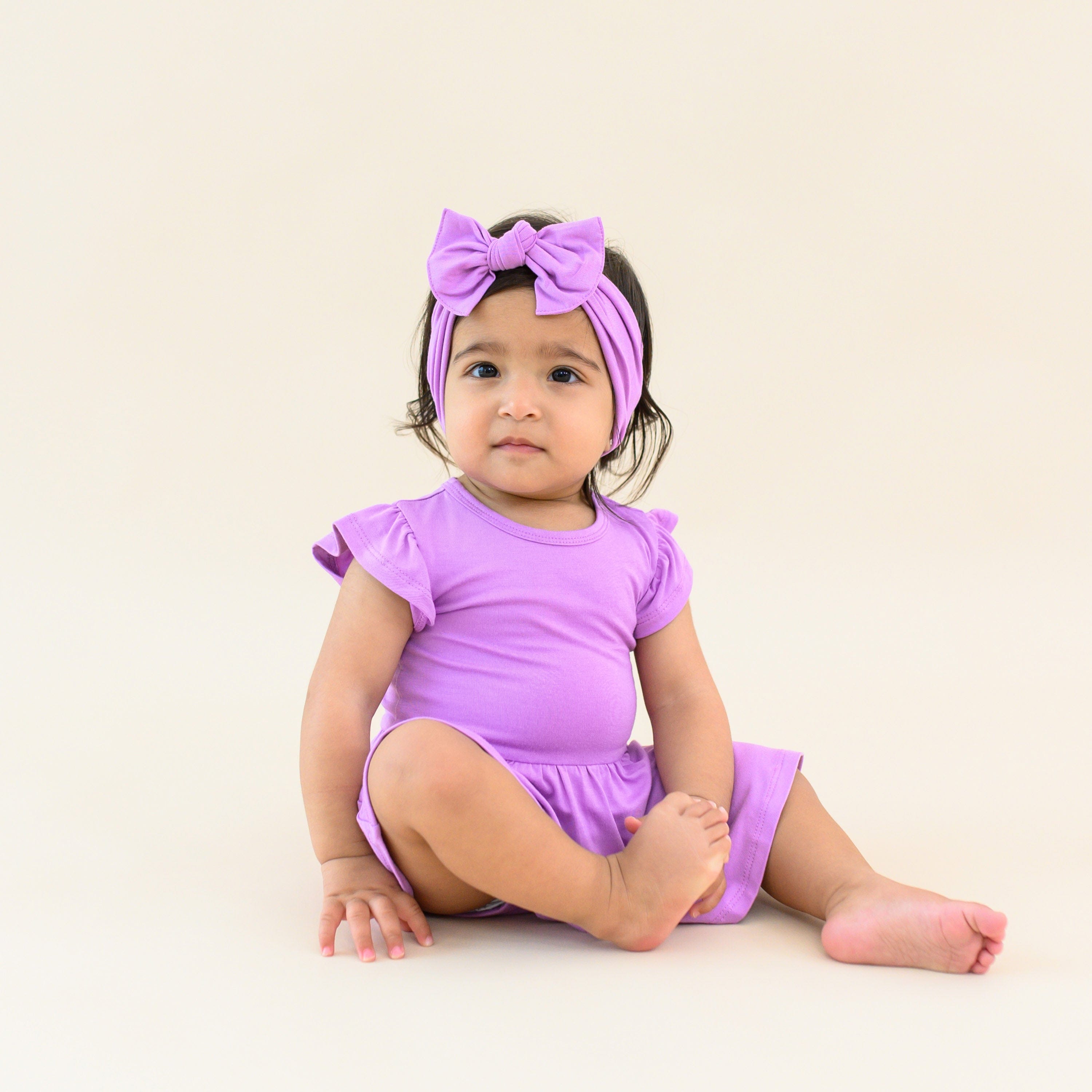 Toddler modeling twirl bodysuit dress and bow in poi