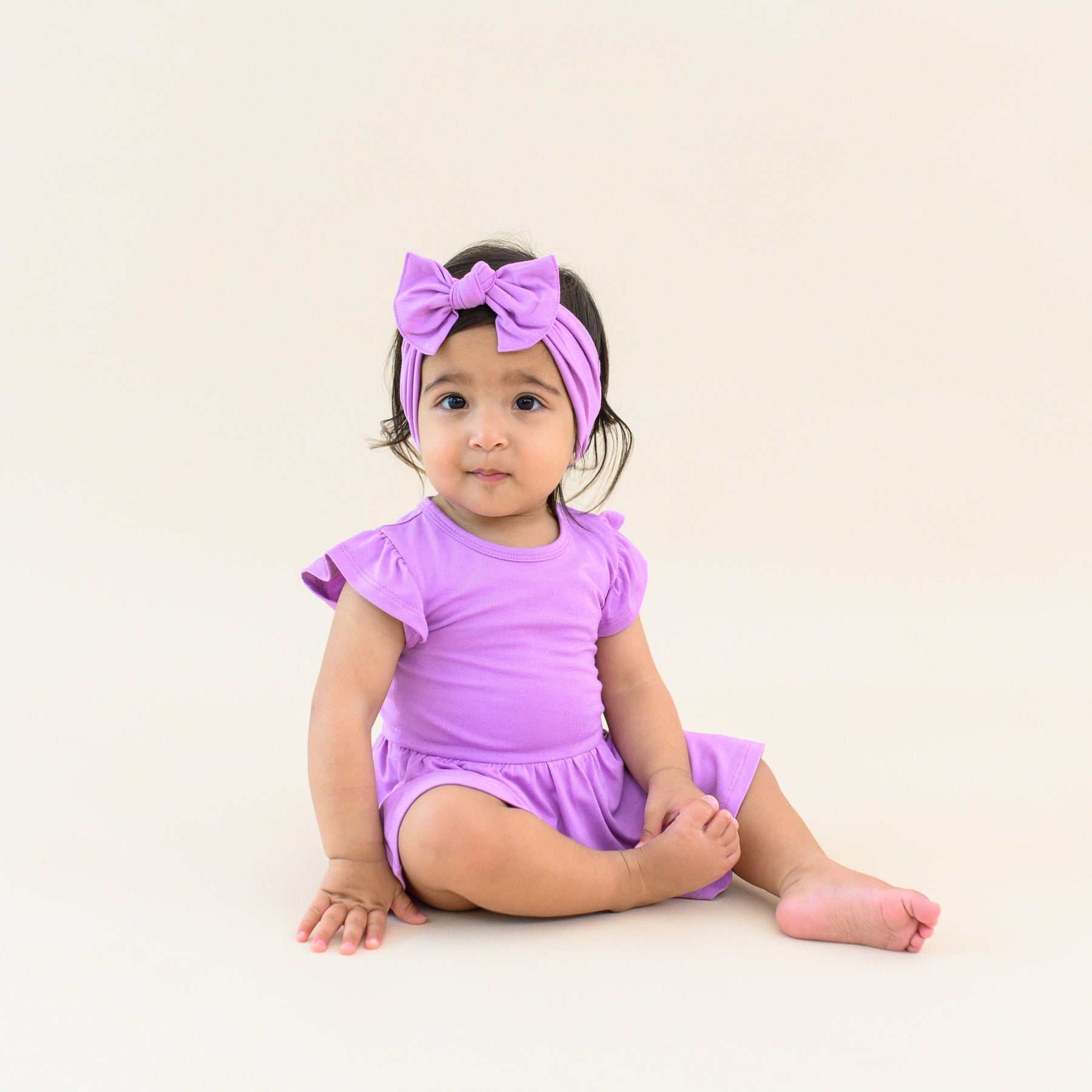 Toddler modeling twirl bodysuit dress and bow in poi