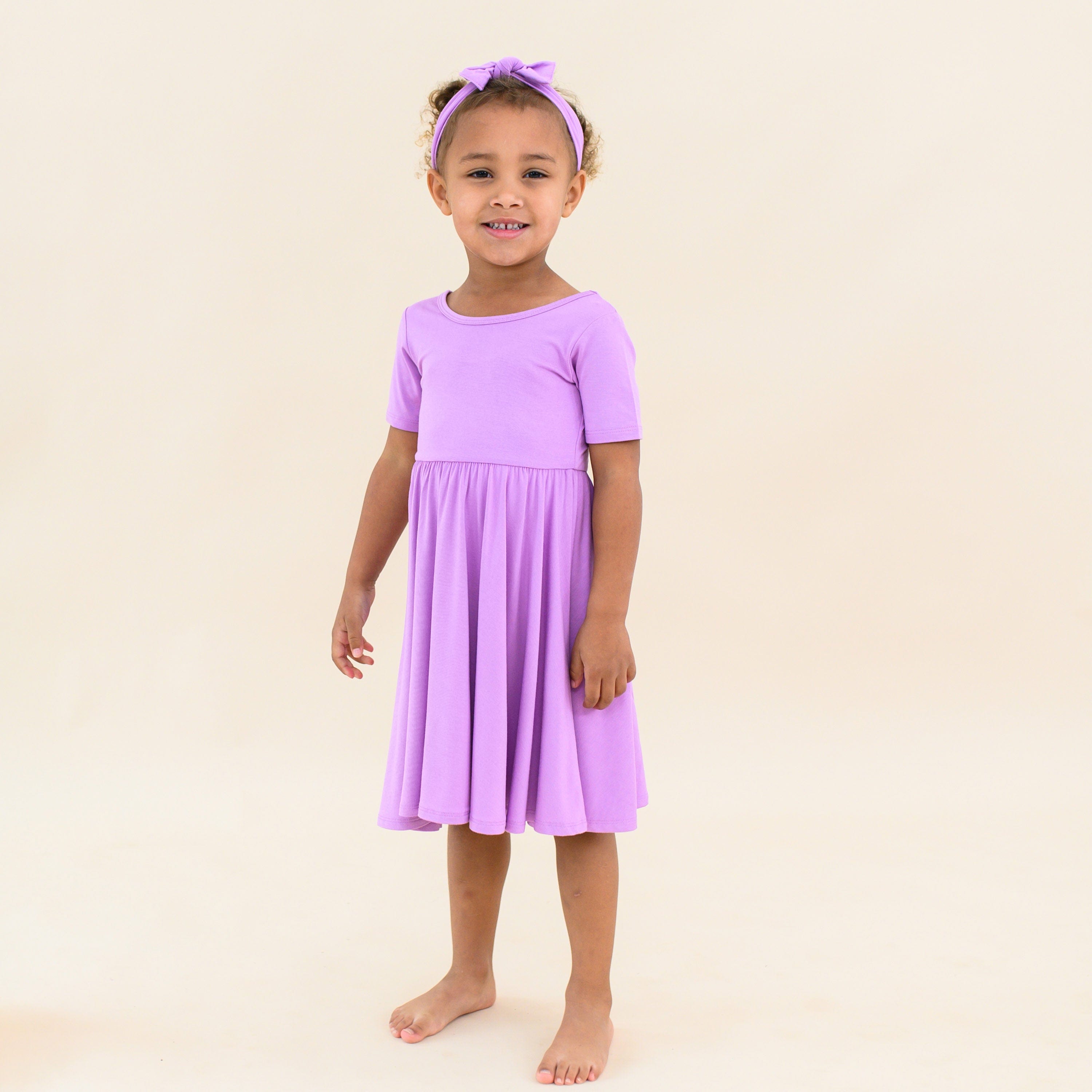 toddler wearing in kyte baby twirl dress in poi