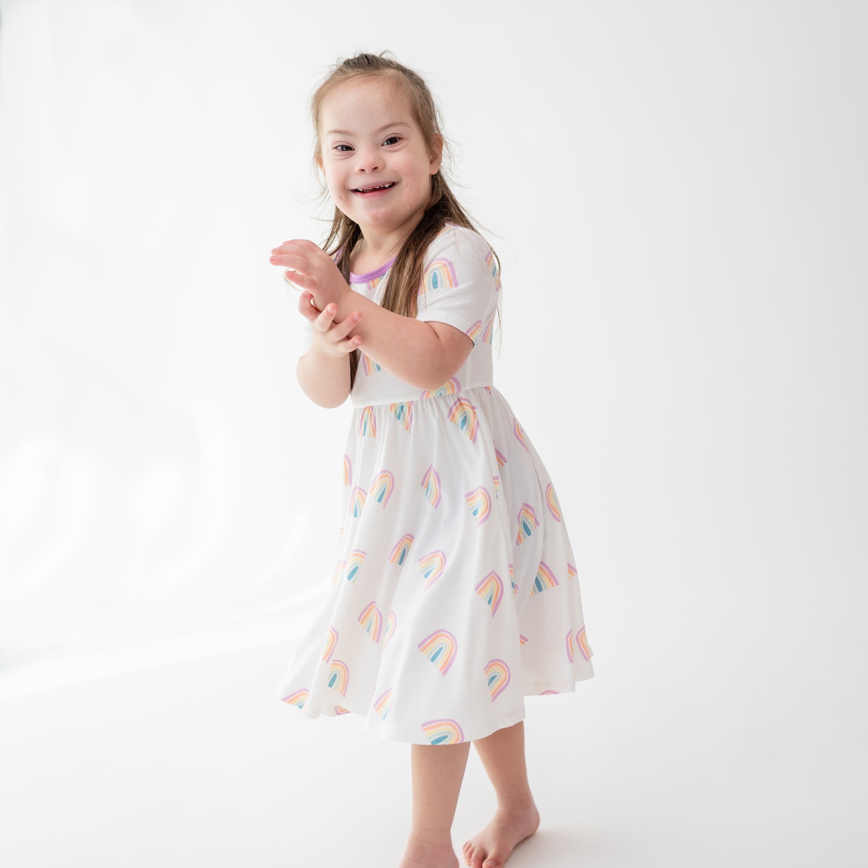 Toddler modeling Twirl Dress in Poi Rainbow 