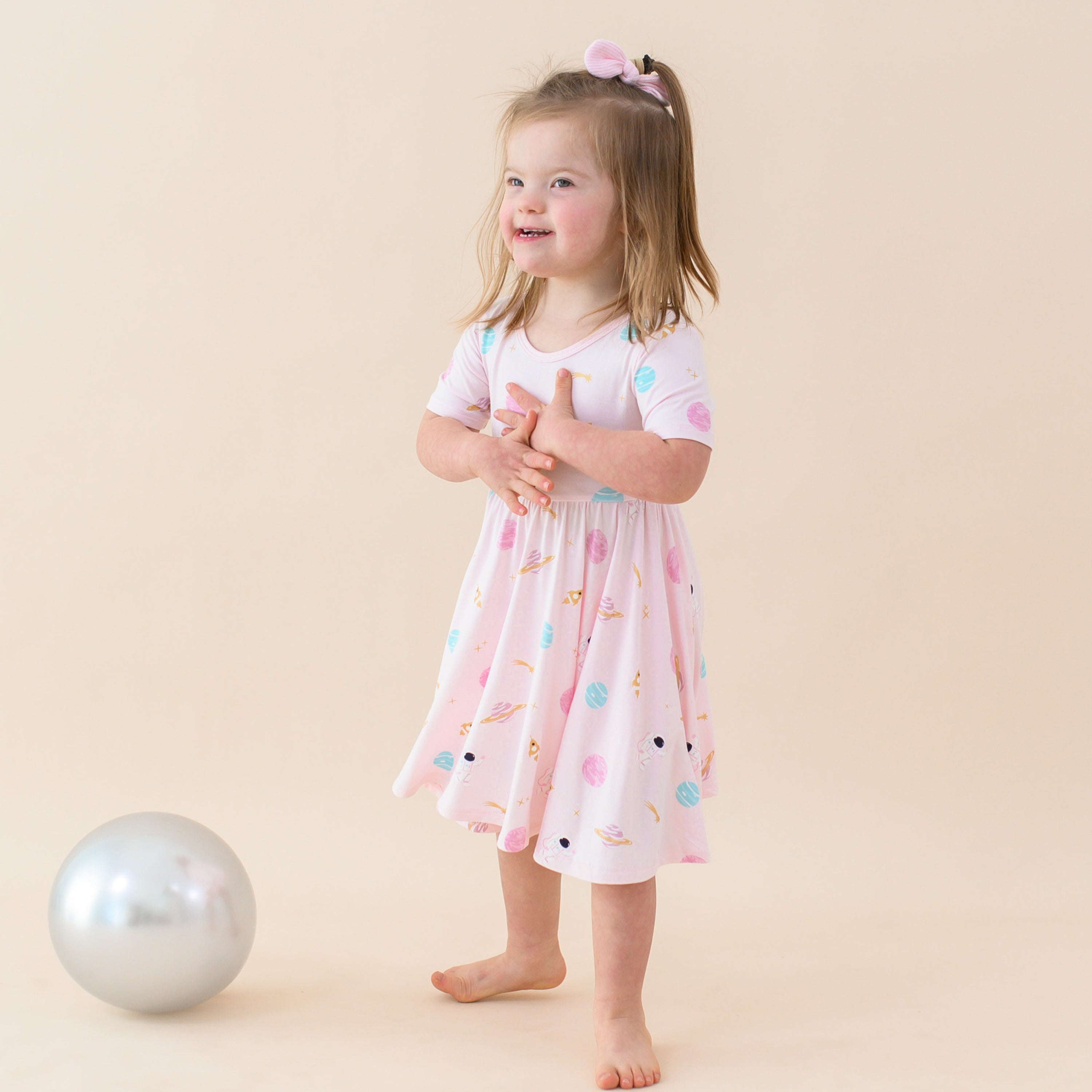 toddler wearing sakura space twirl dress