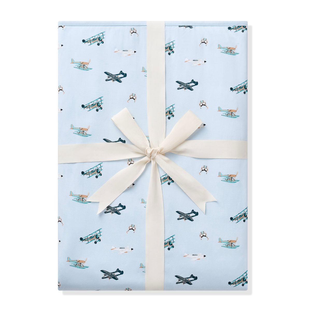 Youth Blanket in Take Off 1.0 shown wrapped in its packaging tied with a linen bow