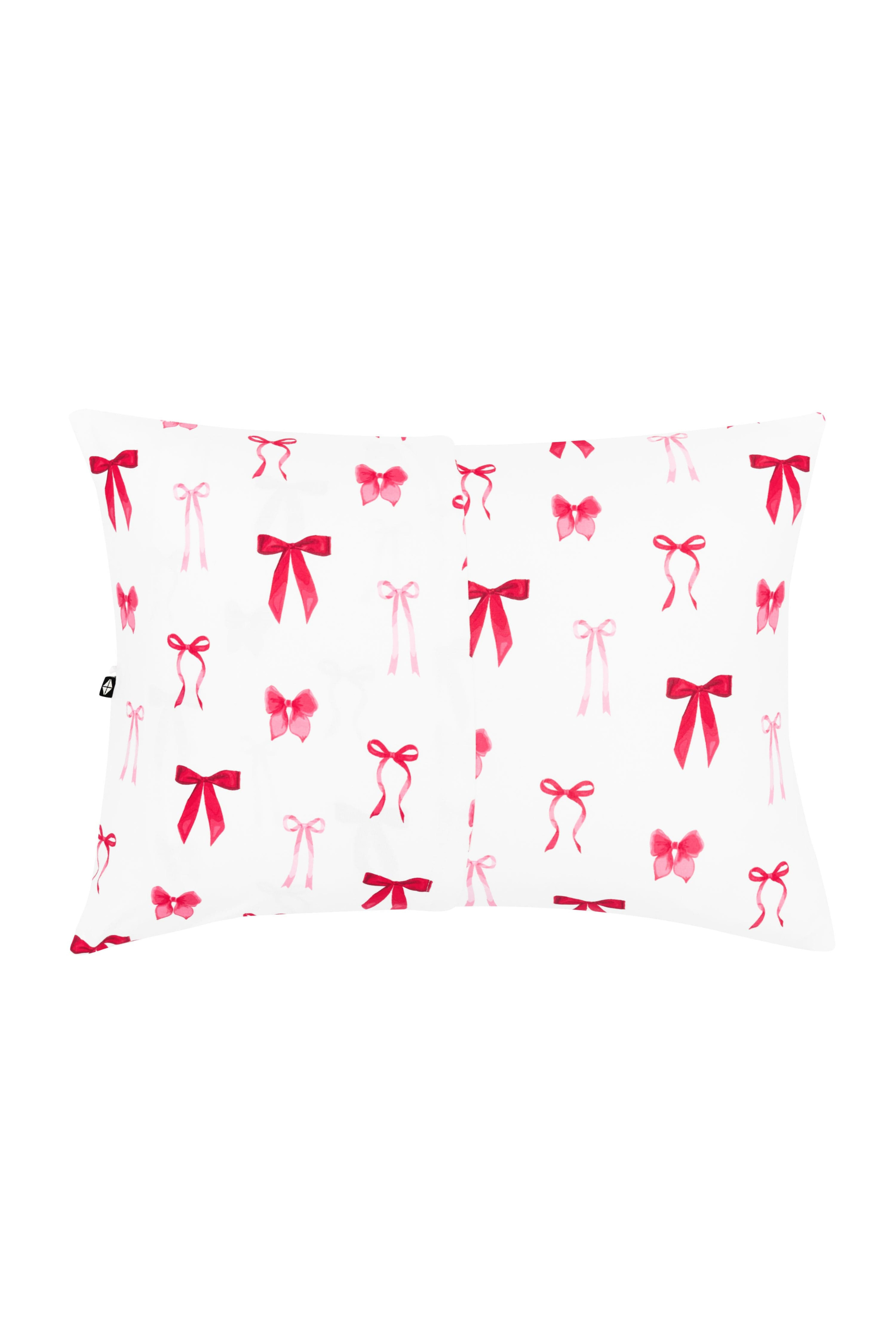 White pillowcase with red and pink bow pattern on a white background