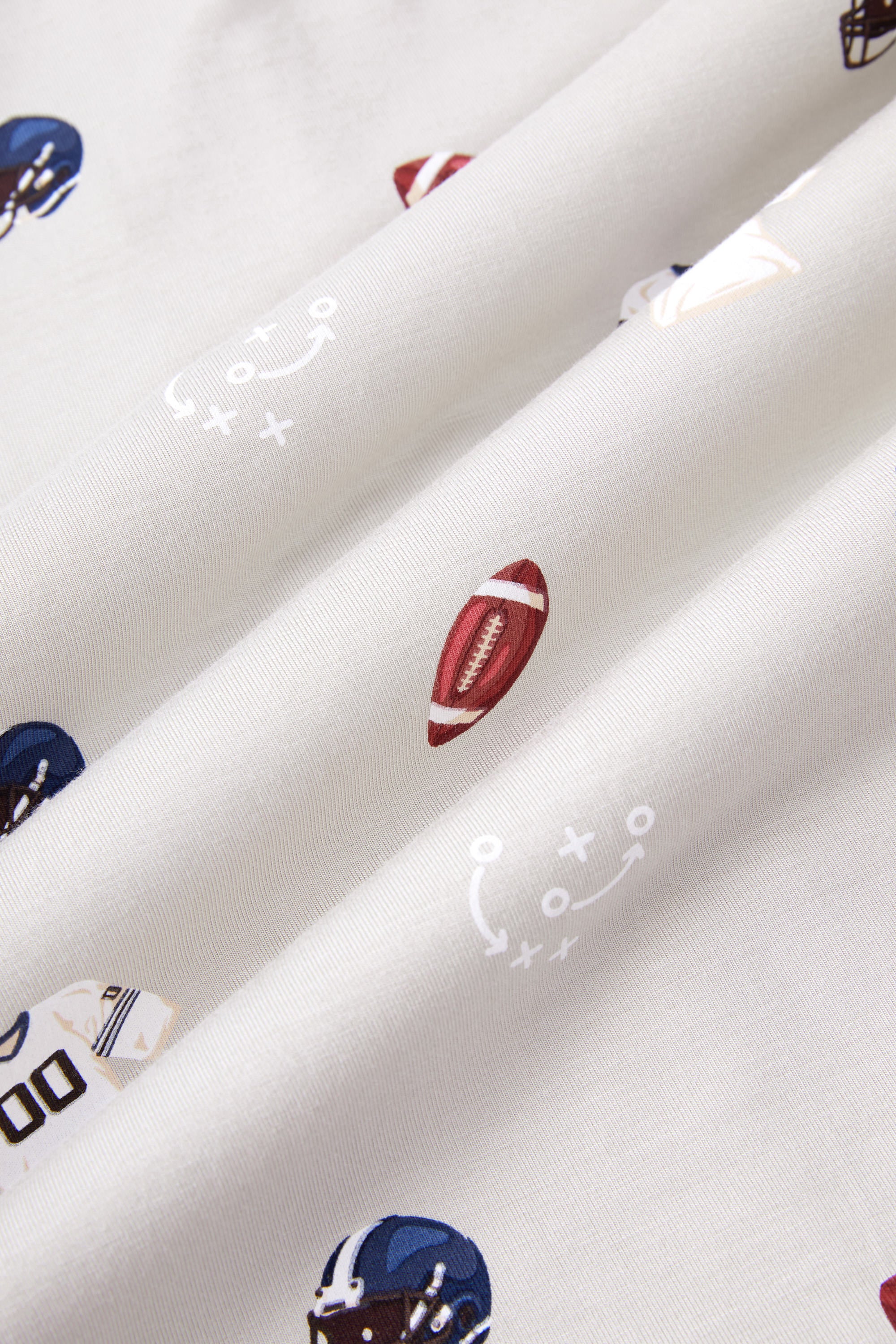 Close up of Vintage Football print on an Oat color fabric