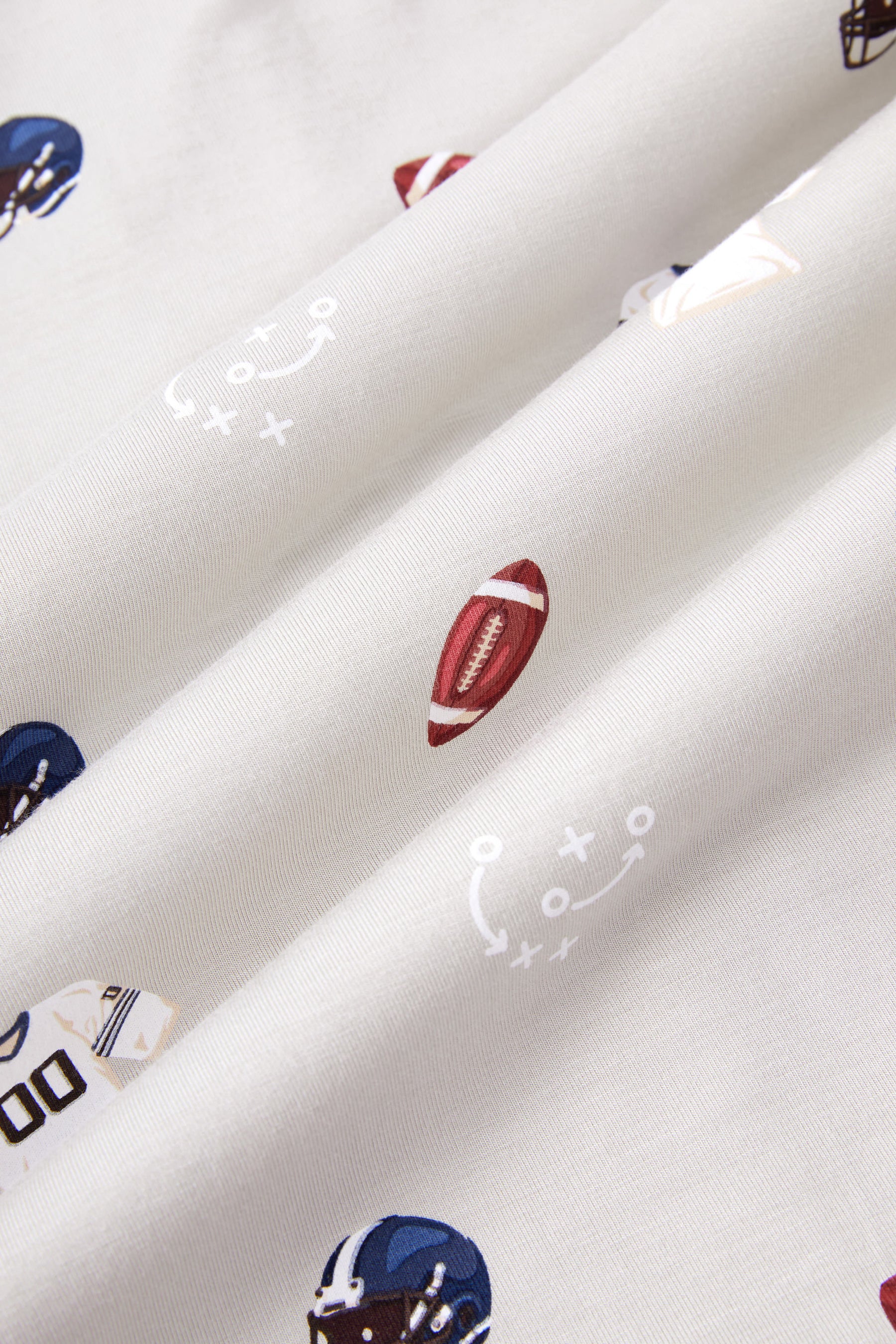 Close up of Vintage Football print on an Oat color fabric