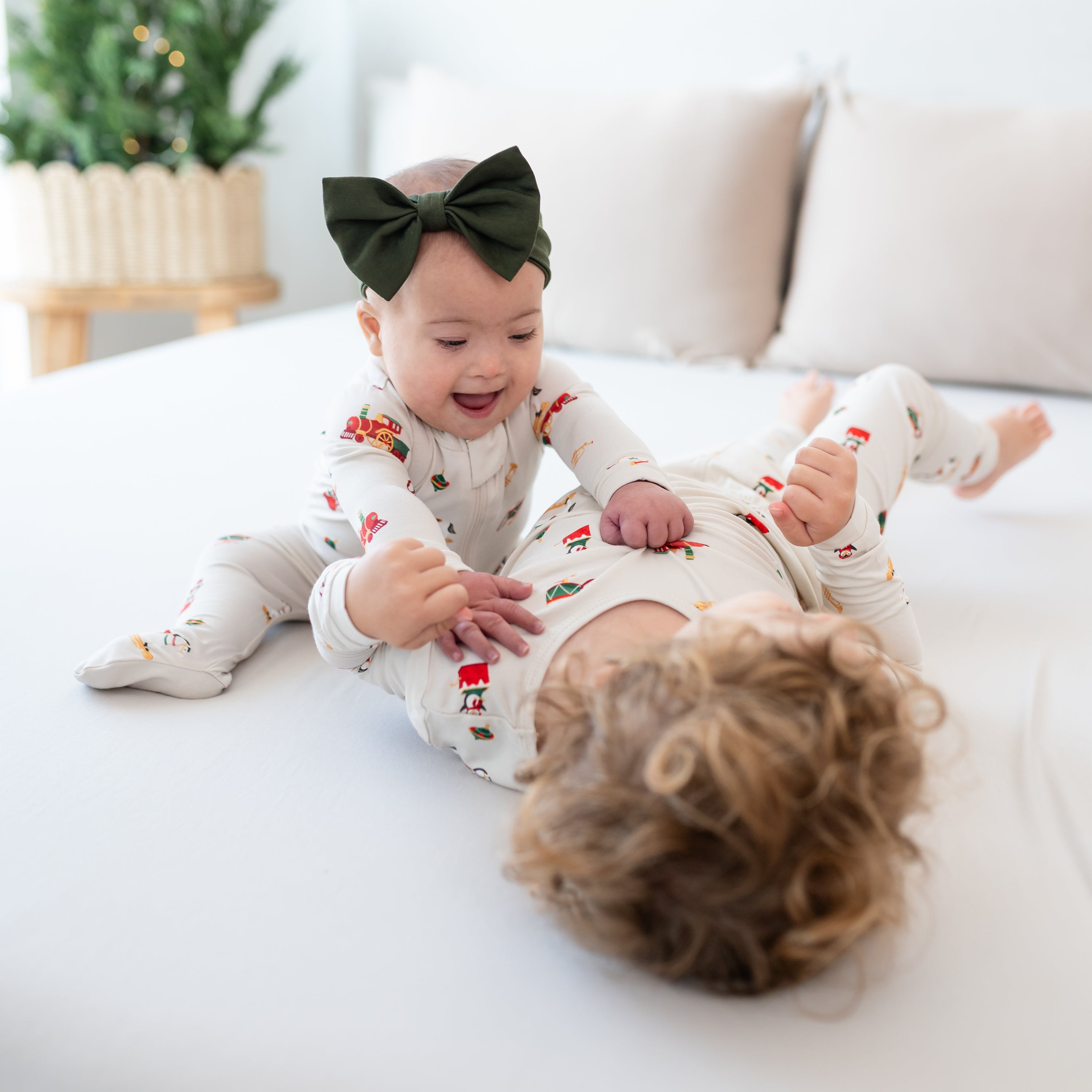 Brother and sister playing on a bed both matching in Vintage Toys