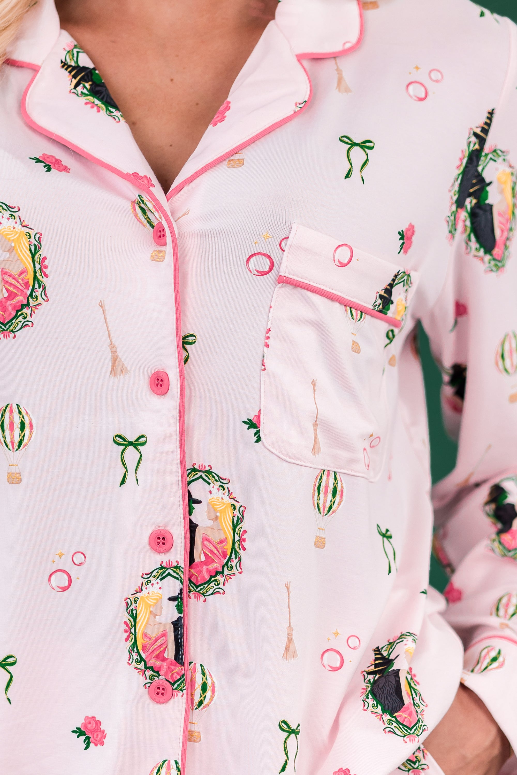 Close up of the button closure, colored trim and chest pocket detail on the Long-Sleeved Women's Pajama Set in Wicked shown on a model