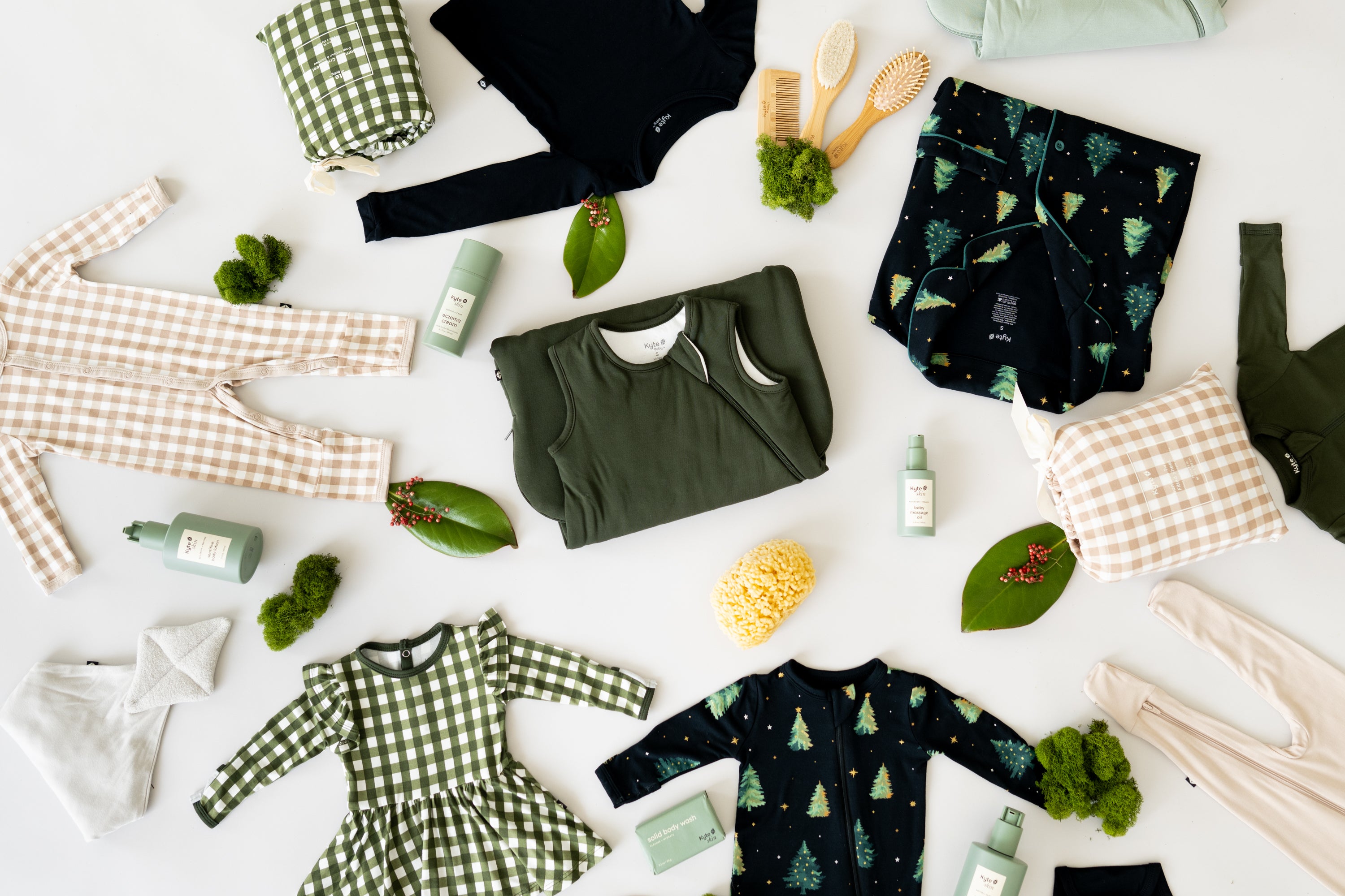 Flat lay of Kyte Baby apparel, sleep bags and accessories