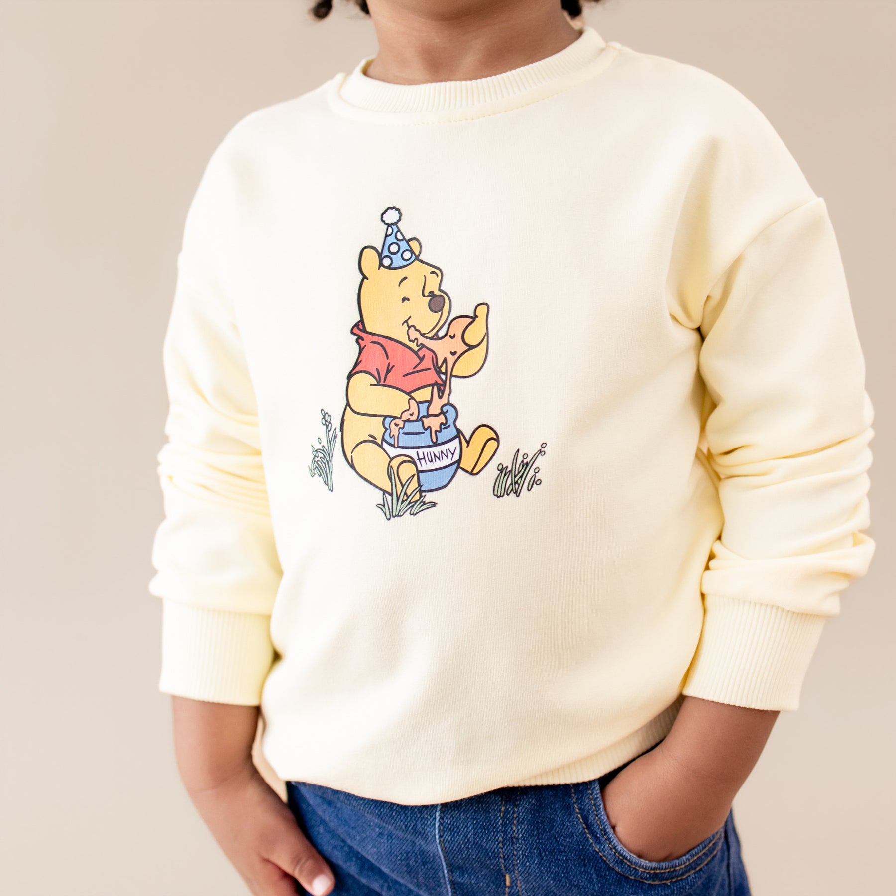 Close up of the Sweatshirt in Winnie the Pooh on Chamomile shown on a young girl