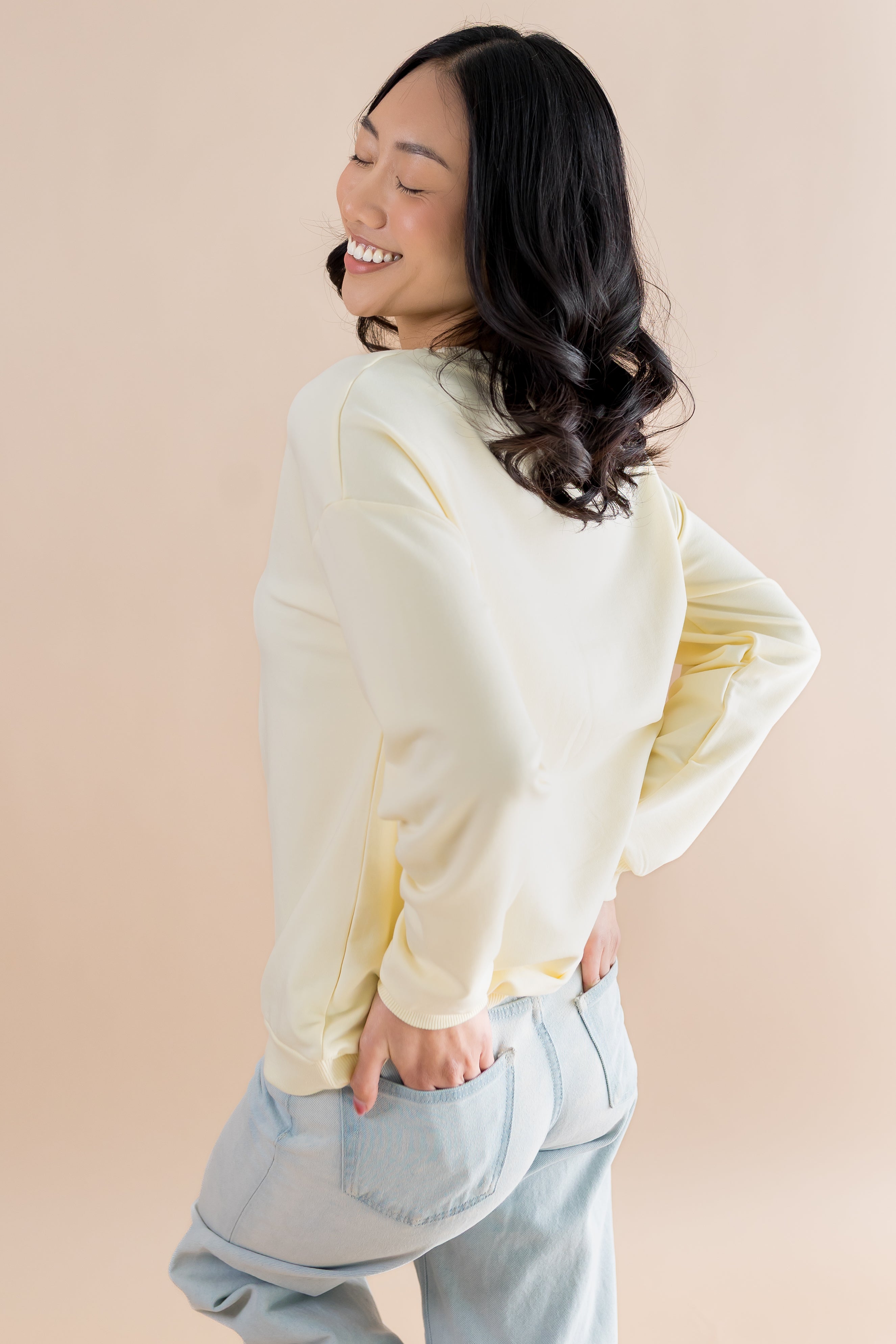 The back of the Women's Sweatshirt in Winnie the Pooh on Chamomile shown on a female model