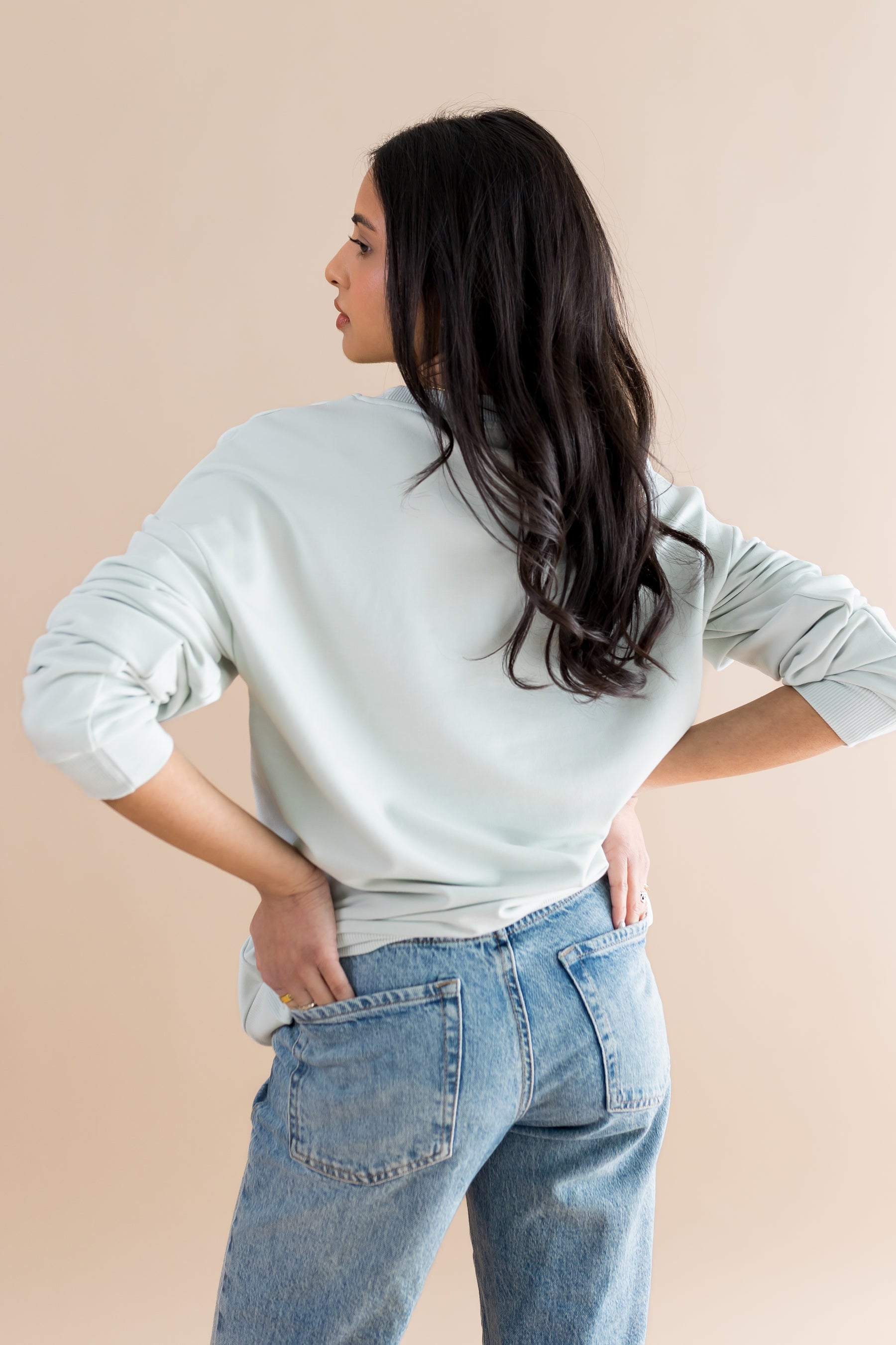 The back of the Women's Sweatshirt in Winnie the Pooh on Dew shown on a female model