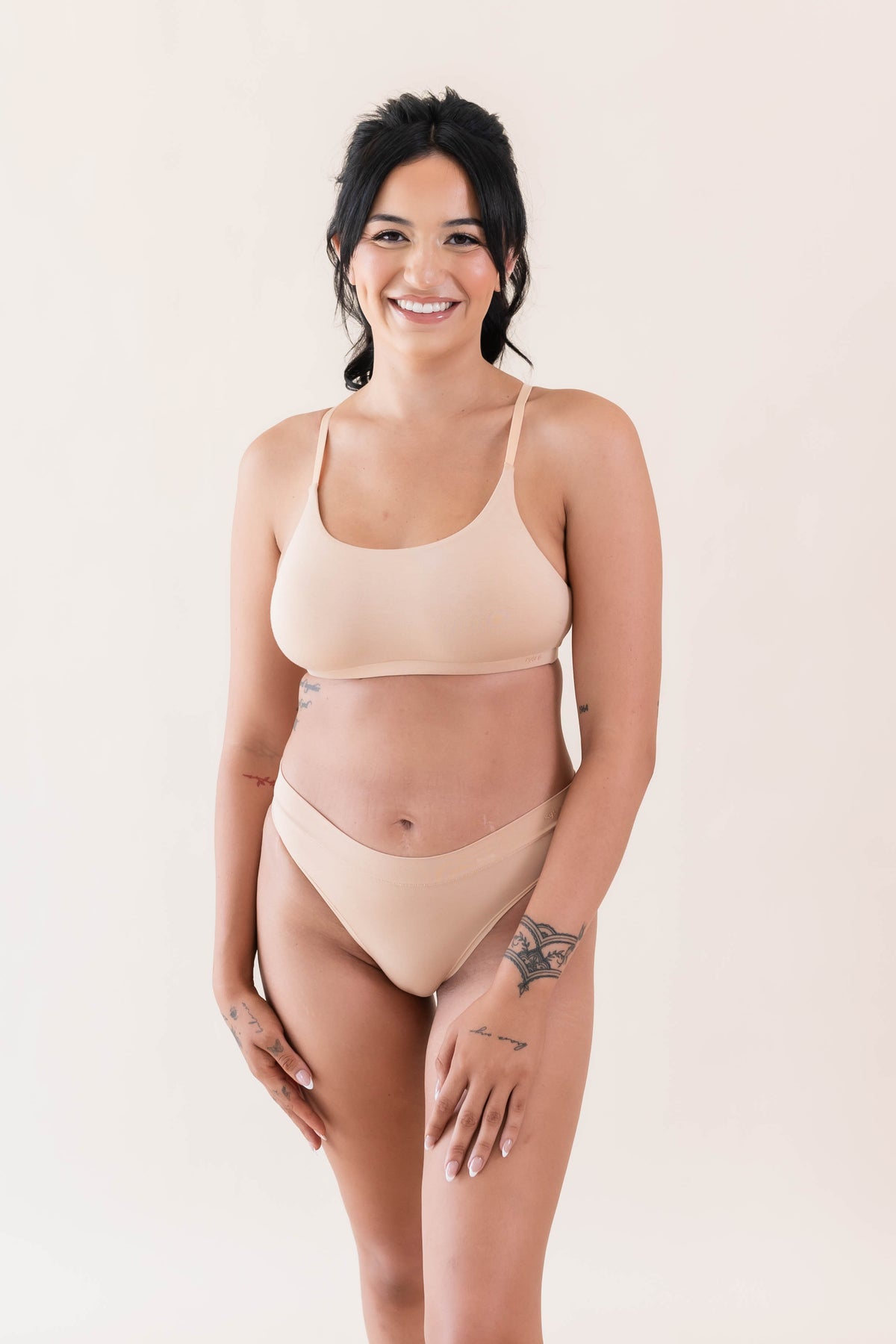 Smiling female model wearing the Women's Cheekini in Chai and matching scoop bralette